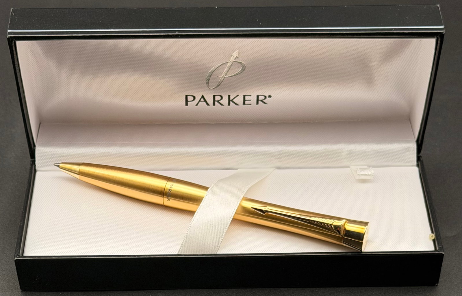 Vintage Parker Classic Gold Plated Ballpoint Pen – Boxed – Arrow Clip – 1980s: Vintage Parker Classic ballpoint pen featuring a brushed gold-plated finish with iconic Parker arrow clip. Twist-action mechanism and script Parker logo engraved on the end cap. Includes original Park