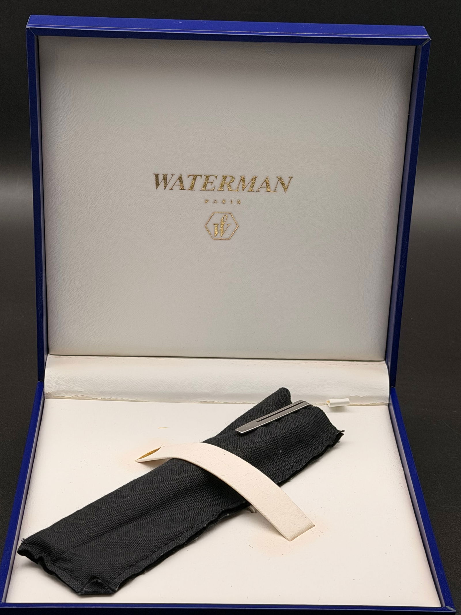 Waterman Paris Blue Rollerball Pen with Silver Trim: Authentic Waterman Paris rollerball pen featuring a deep blue lacquered body with polished silver-tone trim. The pen is marked Waterman Paris on the band and shows classic modern Waterman design.Condi