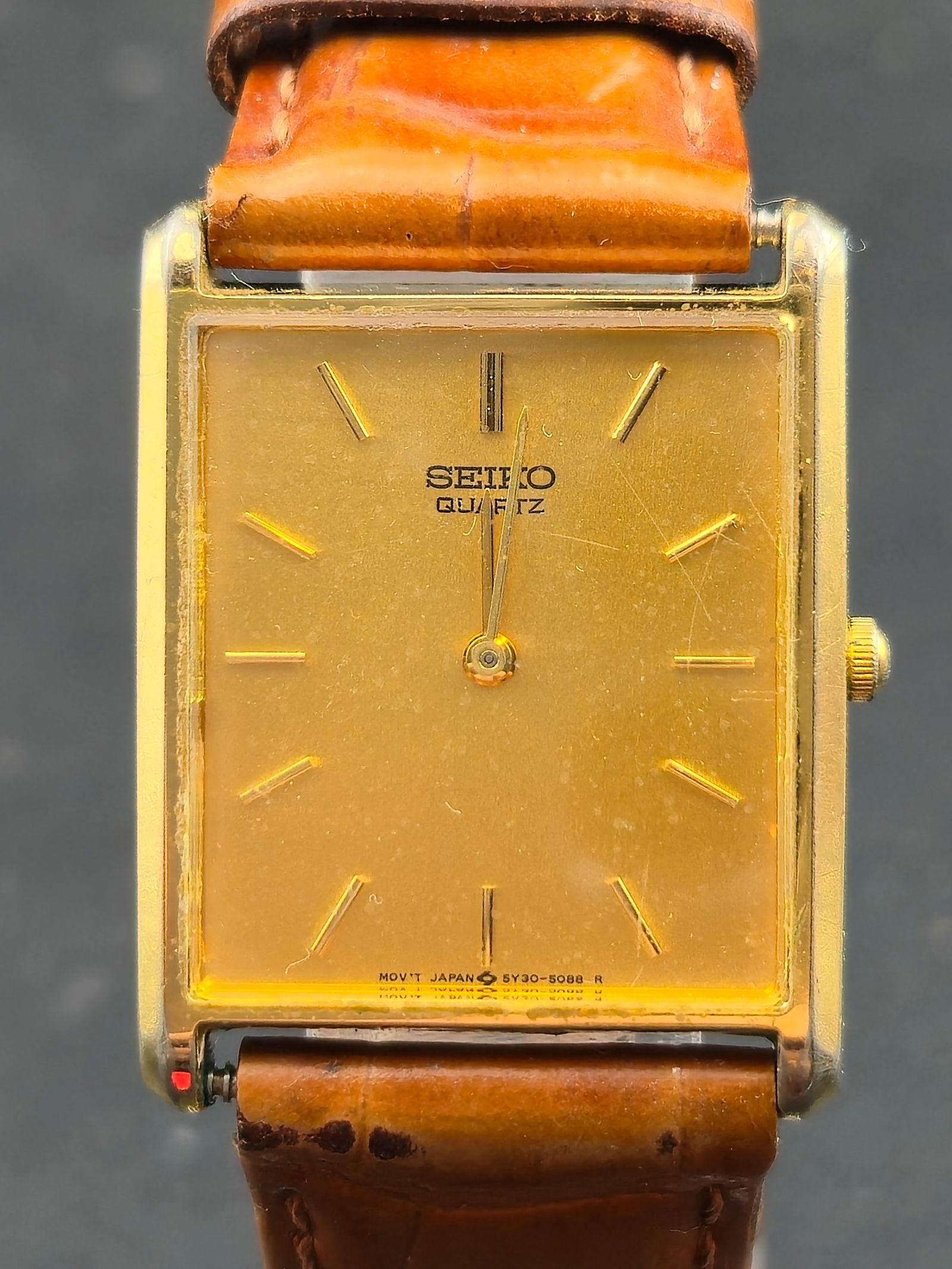 1970s Seiko Quartz Rectangular Gold-Tone 6530-5079 Japan 25mm: Vintage rectangular Seiko Quartz dress watch featuring a minimalist gold dial with applied baton markers. Caseback is clearly marked Base Metal / Stainless Steel Back with reference 6530-5079 and seri