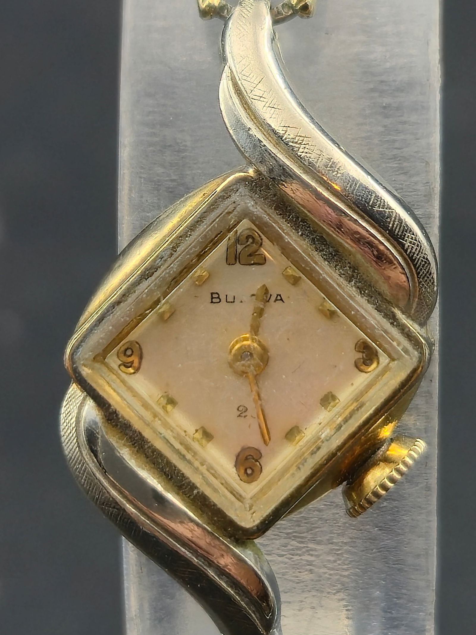 1950s Bulova Ladies Watch 10K RGP Case 23J Manual 13mm Diamond Case Speidel: Vintage Bulova ladies wristwatch dating to the 1950s, featuring a distinctive diamond-shaped case with sculpted lugs. The watch is fitted with a manual-wind Bulova movement marked 23 jewels, visible i