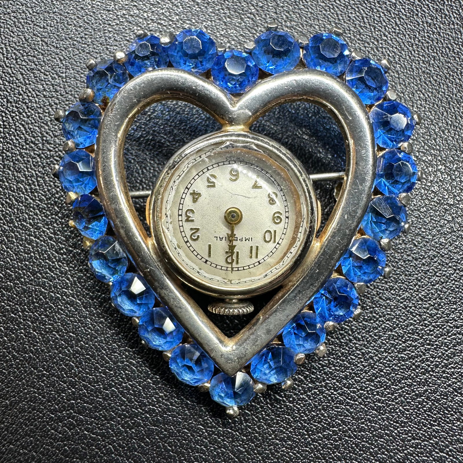 19g Vintage Sterling Silver & Blue Rhinestone Heart Watch Brooch: 19g Vintage Imperial Sterling Silver & Blue Rhinestone Heart Watch BroochBrand/Model: Imperial (watch movement).Manufacturer Location: Swiss (movement marked Swiss).Year Produced: Unknown.Condition: O
