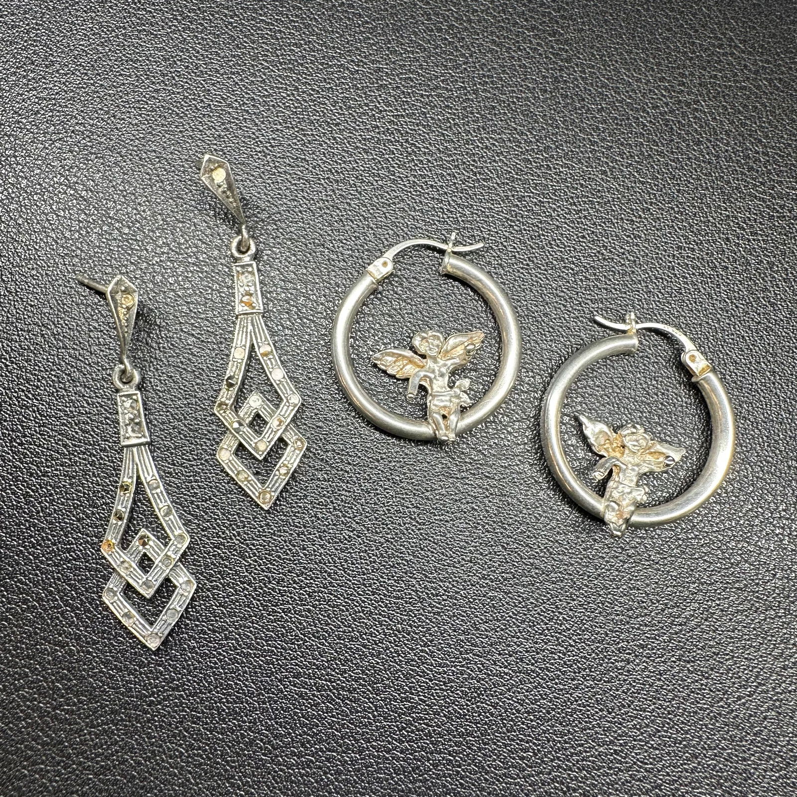9g Sterling Silver Marcasite & Sterling Silver Hoops w/ Angel Motif Earring Lot: 9g Sterling Silver Marcasite & Sterling Silver Hoops w/ Angel Motif Earring Lot:Brand/Model: Unknown brand; mixed styles.Manufacturer Location: Not marked.Year Produced: Unknown.Condition: Overall goo