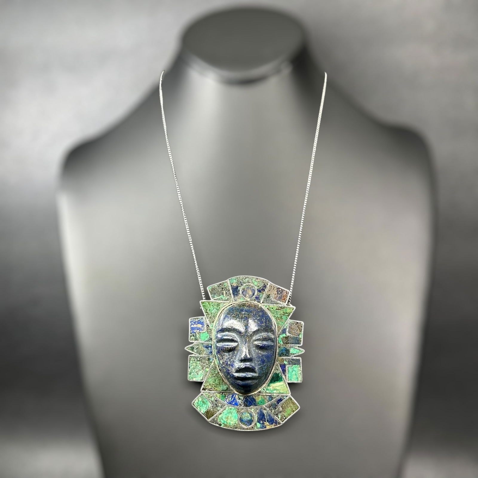 17"/57g Mexican Taxco 925 Sterling Silver Azurite Lapis Lazuli Inlay Carved Aztec Mask Pendant: 17"/57g Mexican Taxco 925 Sterling Silver Azurite Lapis Lazuli Inlay Carved Aztec Mask Pendant:Brand/Model: TAXCO; 925 sterling.Manufacturer Location: Mexico.Year Produced: Unknown.Condition: Overall