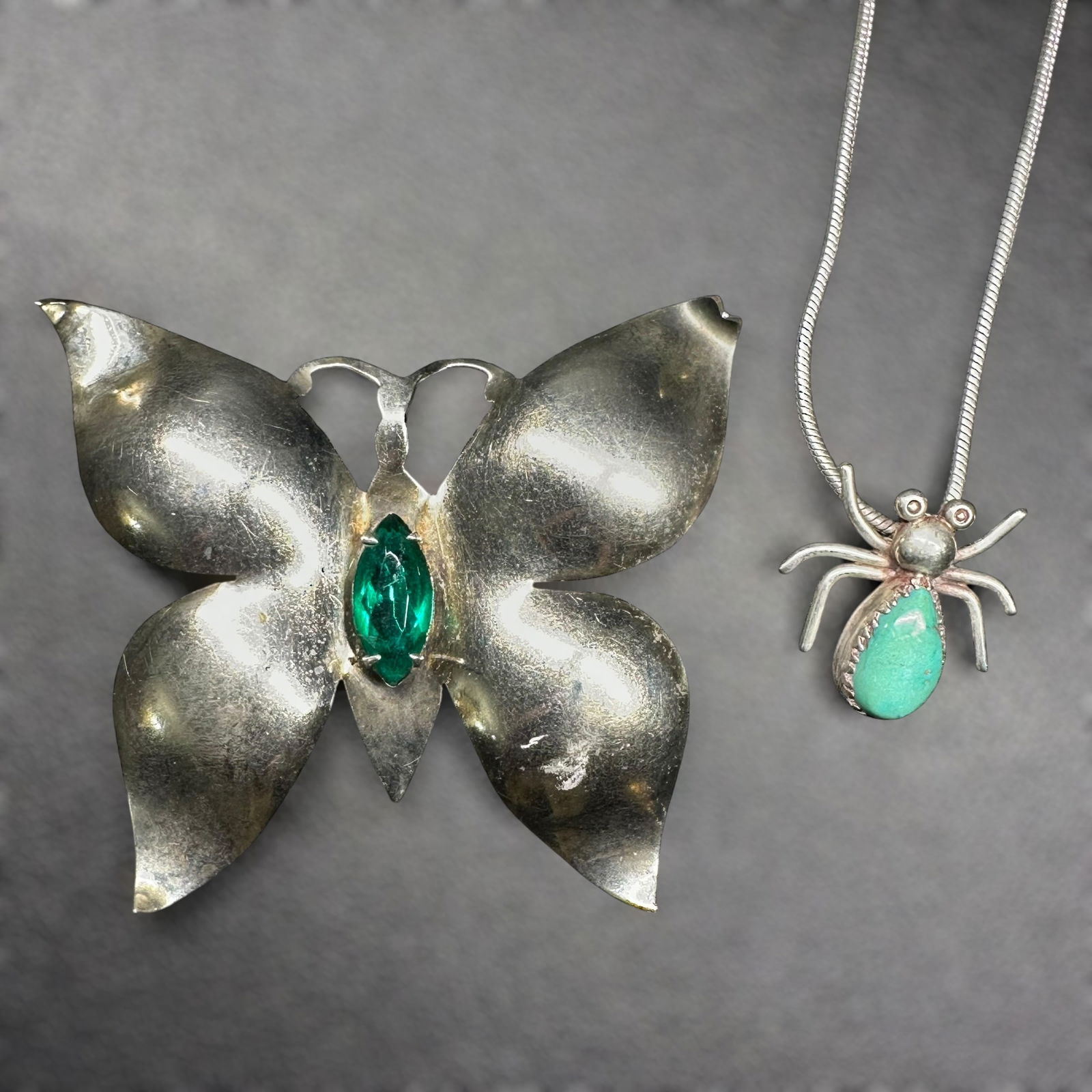 7”/23g 925 Sterling Silver Faceted Green Stone Butterfly & Turquoise Spider Pendant Lot - 2 Pc: 7”/23g 925 Sterling Silver Faceted Green Stone Butterfly & Turquoise Spider Pendant Lot - 2 PcBrand/Model: Hallmark "JB" with crescent moon above initials; Native American Navajo. Unidentified.