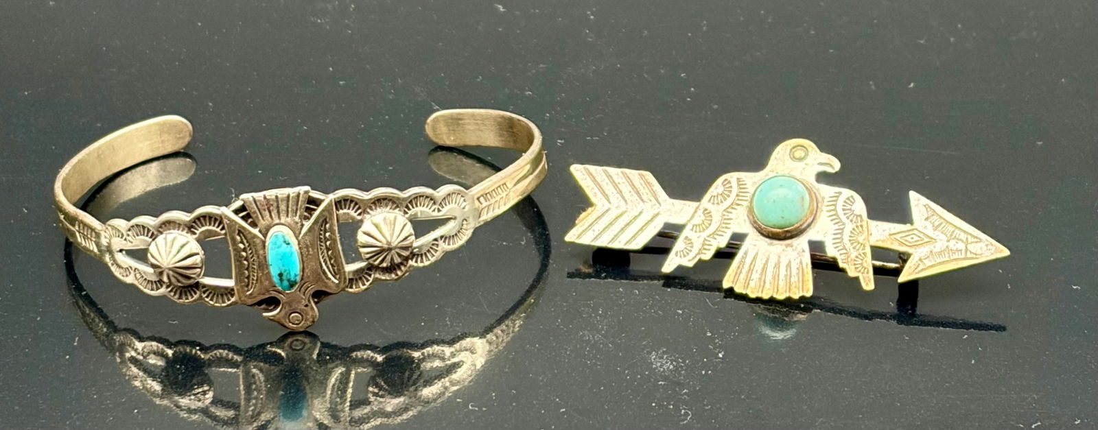 Vintage Southwestern Sterling Silver Cuff Bracelet & Thunderbird Arrow Brooch with Turquoise: A striking vintage Southwestern pairing featuring a hand-crafted sterling silver cuff bracelet and a matching Thunderbird arrow brooch, both accented with natural turquoise. The cuff displays classic