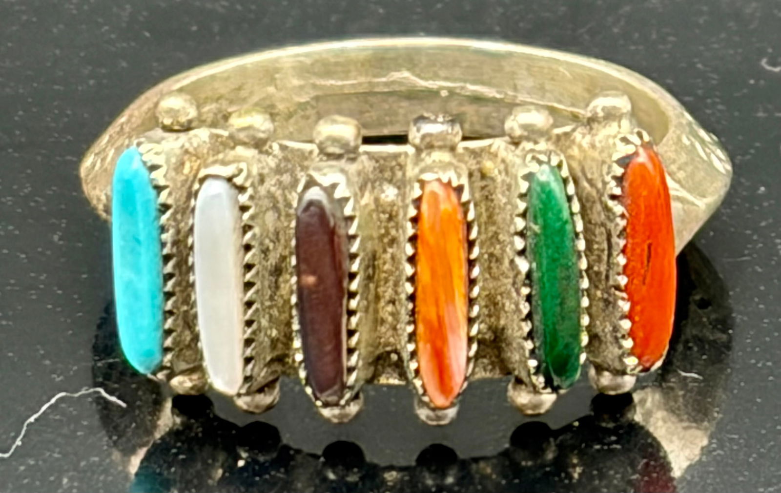 Vintage Sterling Silver Multistone Southwestern Band Ring: This eye-catching vintage band ring features a vibrant row of vertically set marquise-shaped stones in a rich palette of colors, including turquoise blue, milky white, deep brown, warm amber, emerald