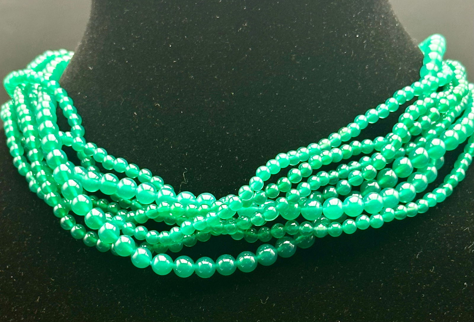 Tiffany & Co. Green Multi-Strand Bead Necklace: Authentic Tiffany & Co. multi-strand beaded necklace featuring glossy green round beads arranged in layered strands. Finished with a twisted sterling silver hook clasp, stamped 925 Italy Tiffany & Co.