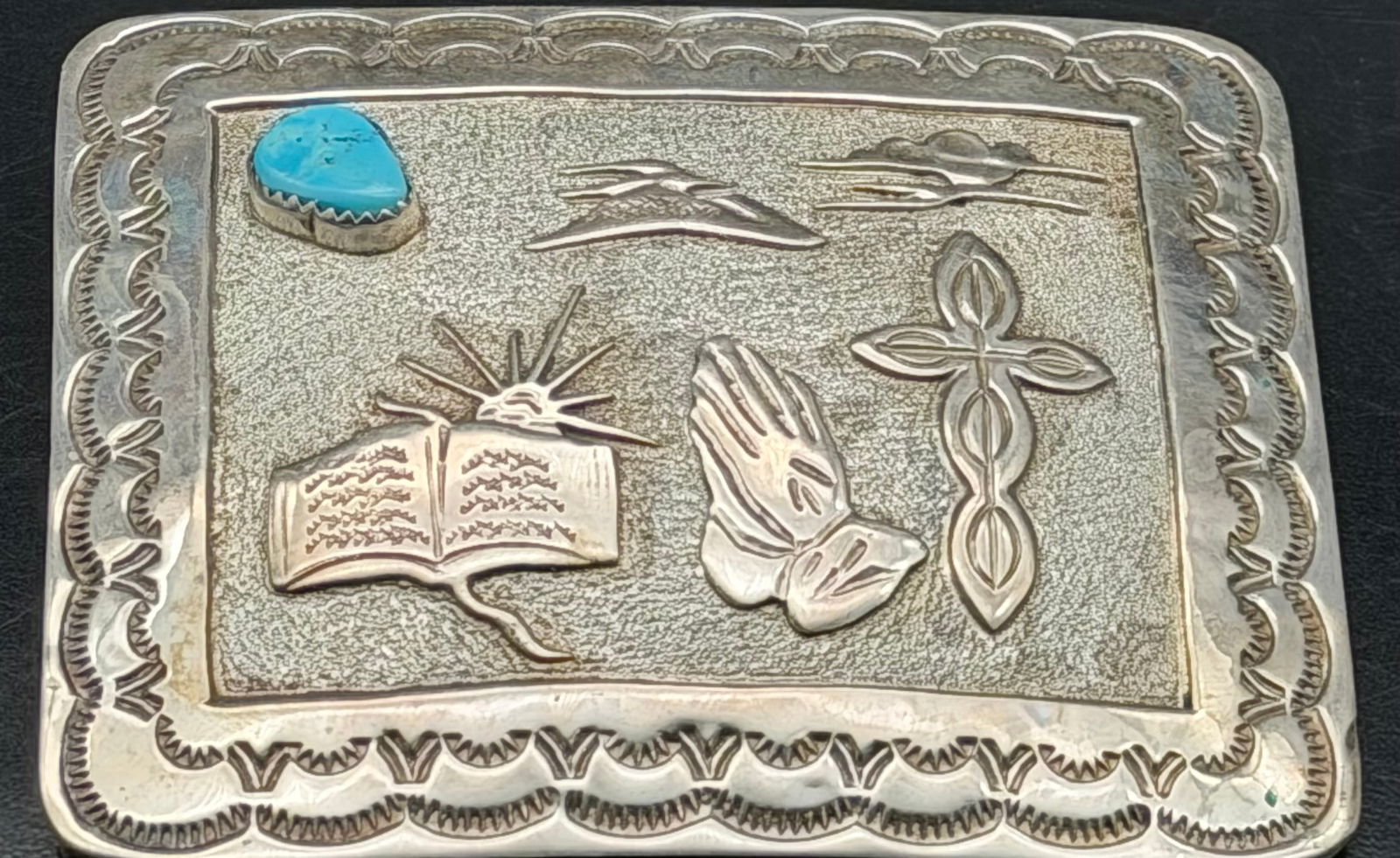 Vintage Sterling Silver Turquoise Western Belt Buckle – 56g: Vintage sterling silver belt buckle with detailed Western/Christian motifs, including an open Bible, praying hands, cross, clouds, and sunburst. Features a small turquoise stone accent.