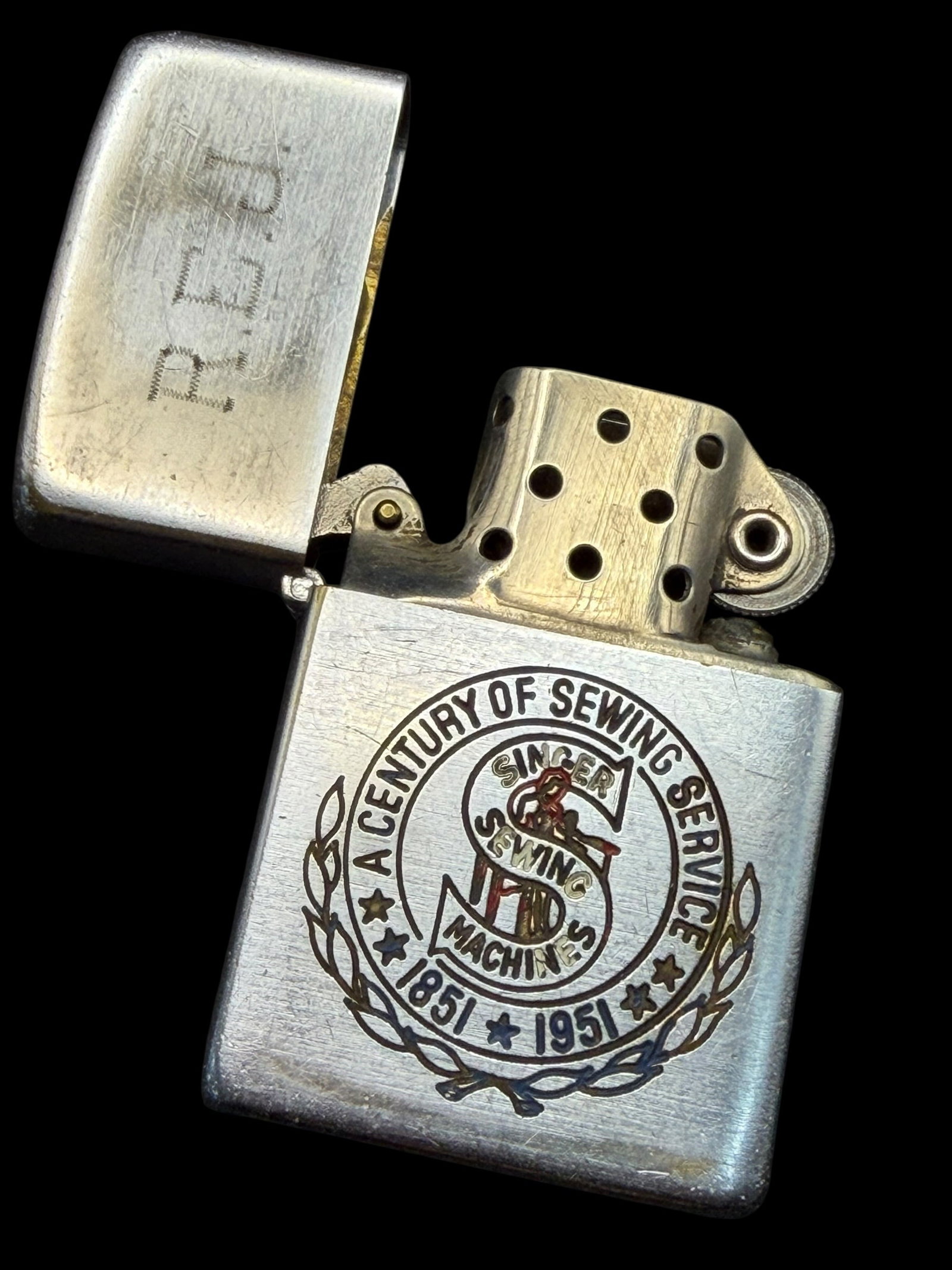 Vintage 1951 Singer Sewing Machines 100 Years Century of Service Zippo Lighter: Brand: Zippo. / Model: A Century of Sewing Service, Singer Sewing Machines, 1851-1951. / Material: Steel. / Size: 2.25” x 1.5” x .5”. / Condition: Overall a very nice lighter. Some w