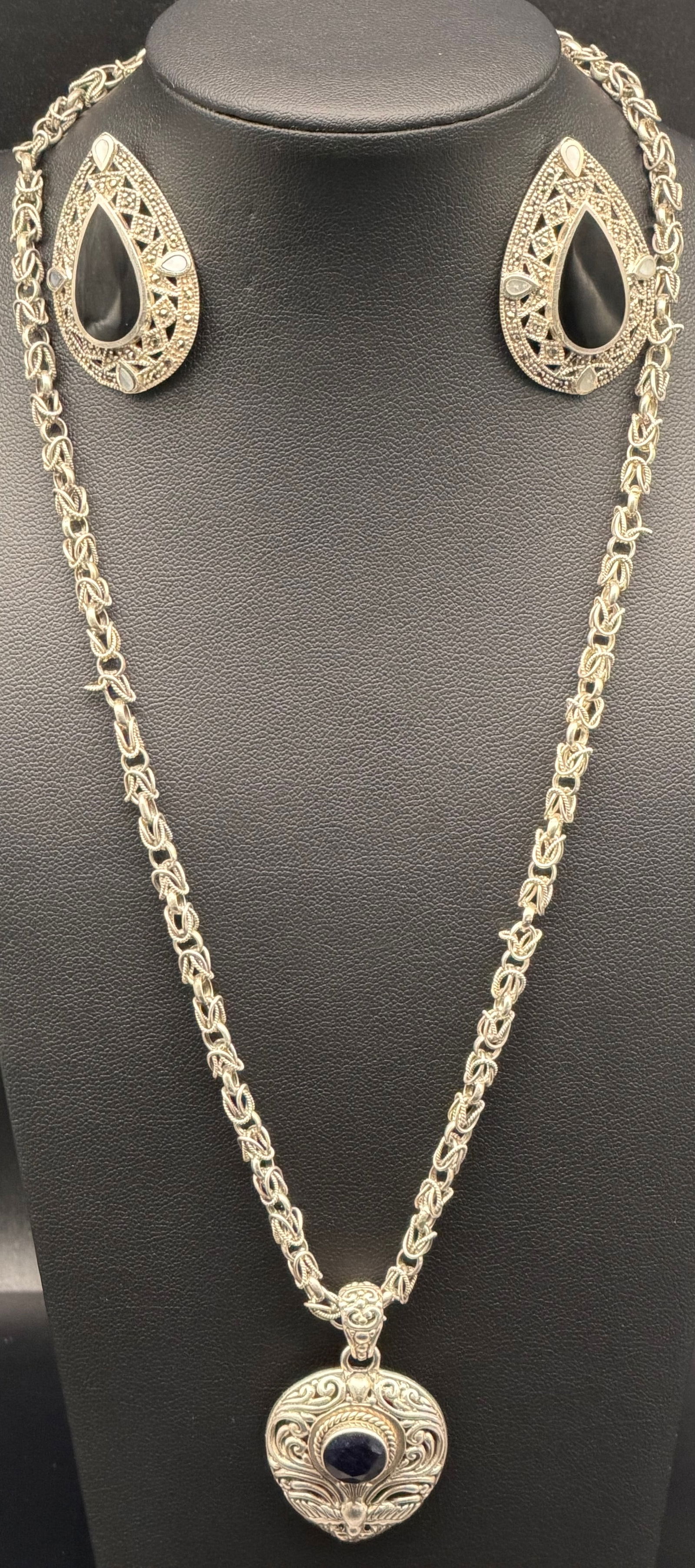 Sterling Silver Pendant Necklace & Earrings -35g: Vintage sterling silver necklace with matching drop earrings, all stamped 925. Features an ornate round pendant with detailed scrollwork and a dark blue cabochon stone, paired with a decorative sterli