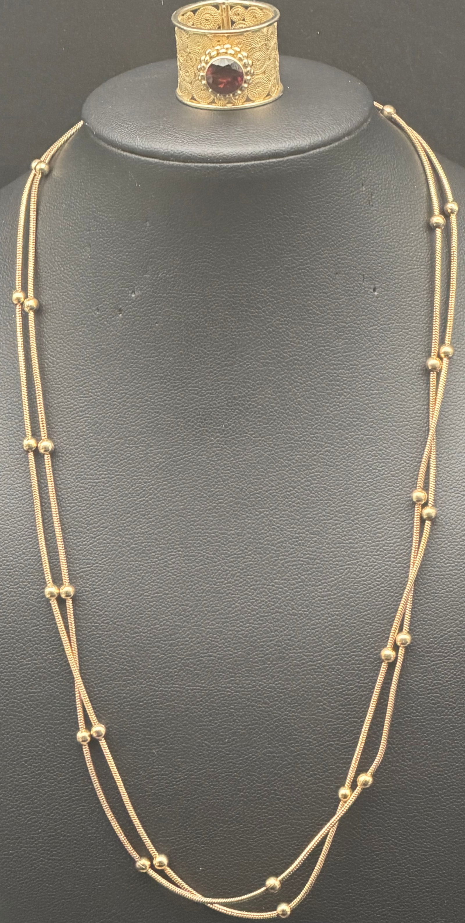 Vintage Gold Tone Multi Strand Bead Necklace & Red Stone Ring Set 18g: Vintage gold-tone jewelry set including a multi-strand bead station necklace and a wide filigree ring with deep red center stone. Elegant coordinated look with textured detailing and layered chain des