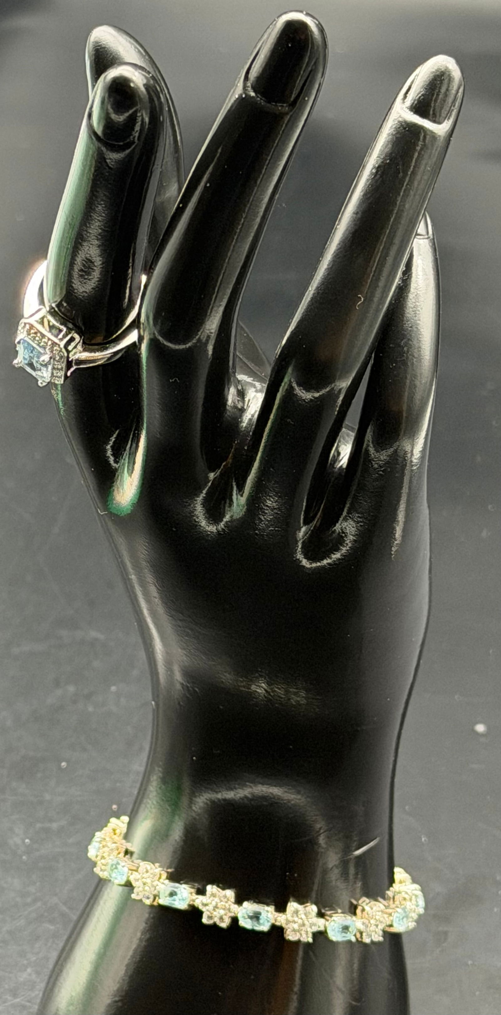 Elegant 925 Sterling Silver Blue Stone Ring & Bracelet Set 18g: Sterling silver jewelry set including a halo-style emerald-cut blue stone ring and a linked stone bracelet with alternating light green/clear stones.