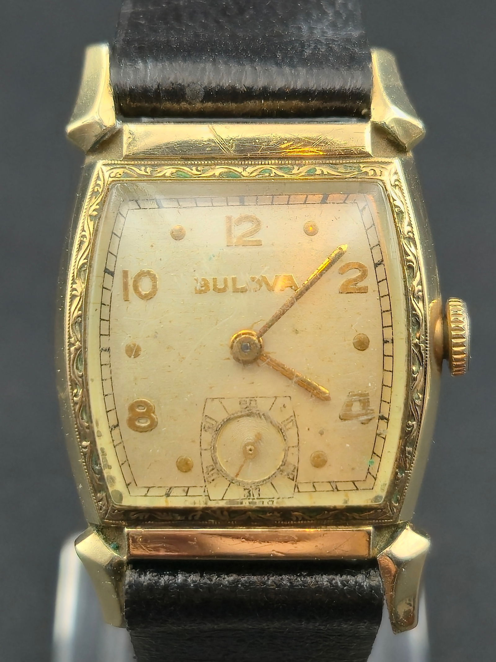 1948 Bulova Rectangular Wristwatch 10K Rolled Gold Plate A8: Vintage 1948 Bulova rectangular wristwatch featuring a classic cream dial with applied Arabic numerals and subsidiary seconds at 6 o’clock. The watch is housed in a 10K rolled gold plate case with a