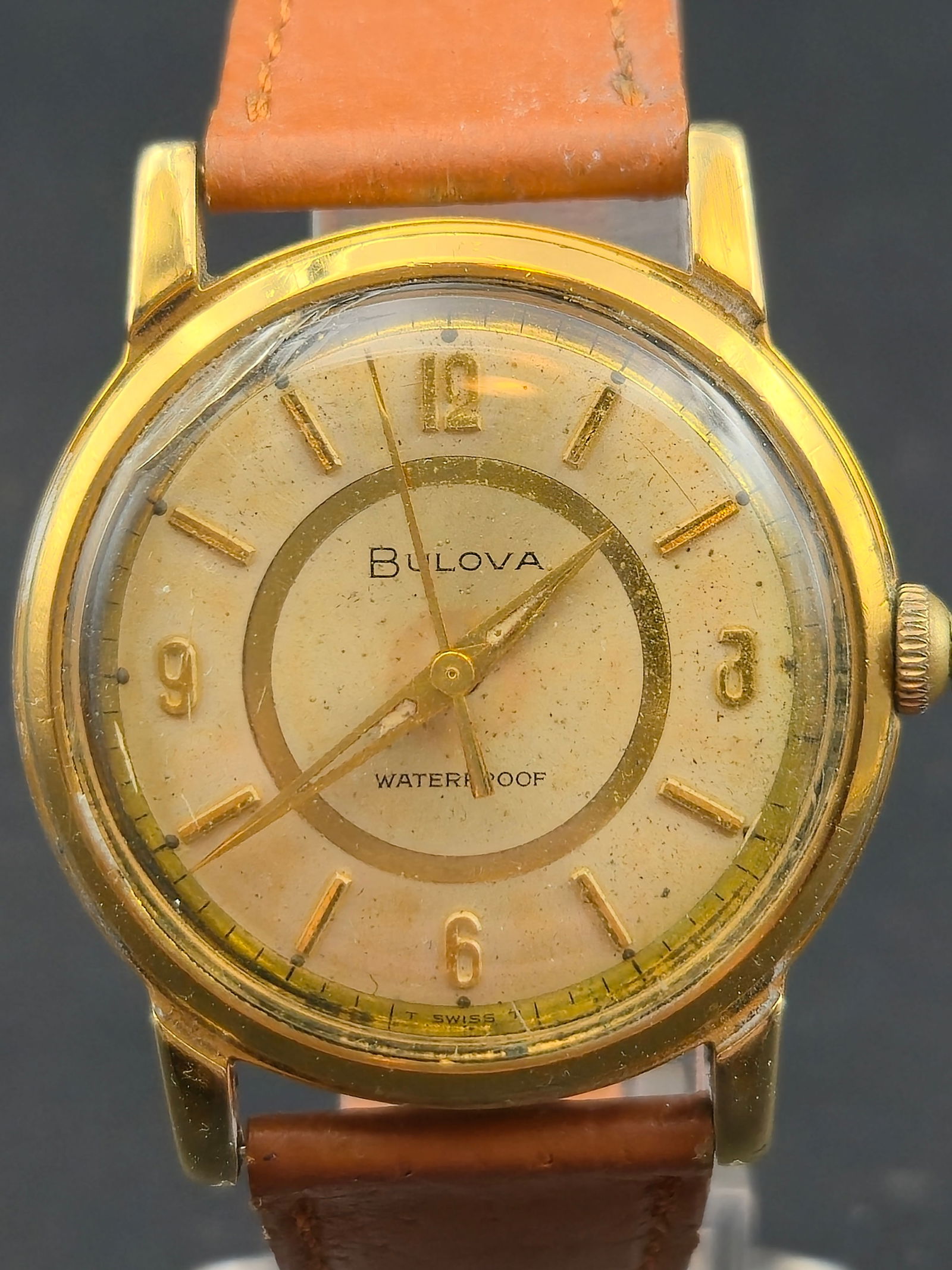 1964 Bulova Automatic Waterproof M4 17J 10 Micron 18K Gold Electroplated 32.9mm Runs: Vintage Bulova automatic wristwatch dated 1964 (M4). Dial is signed Bulova and marked Waterproof, with applied gold-tone hour markers and matching hands. Caseback is stamped 10 microns of 18K gold ele