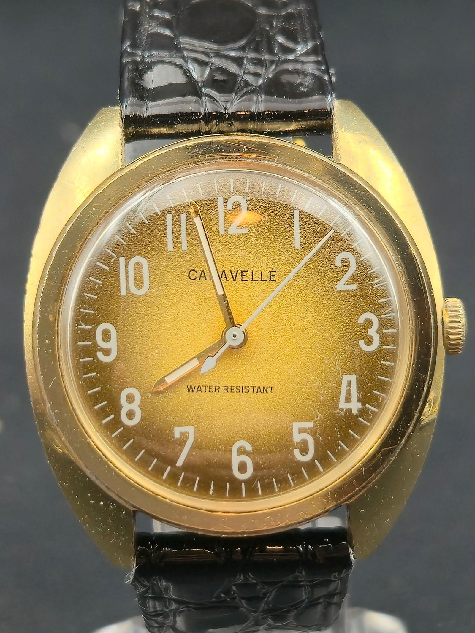 1976 Caravelle by Bulova N6 Mechanical 17J 34.5mm Gold Tone Stainless Back Runs: Vintage Caravelle by Bulova wristwatch dated 1976 (N6). Gold-tone case with base metal bezel and stainless steel back. Dial is signed Caravelle and marked Water Resistant, with Arabic numerals and mat