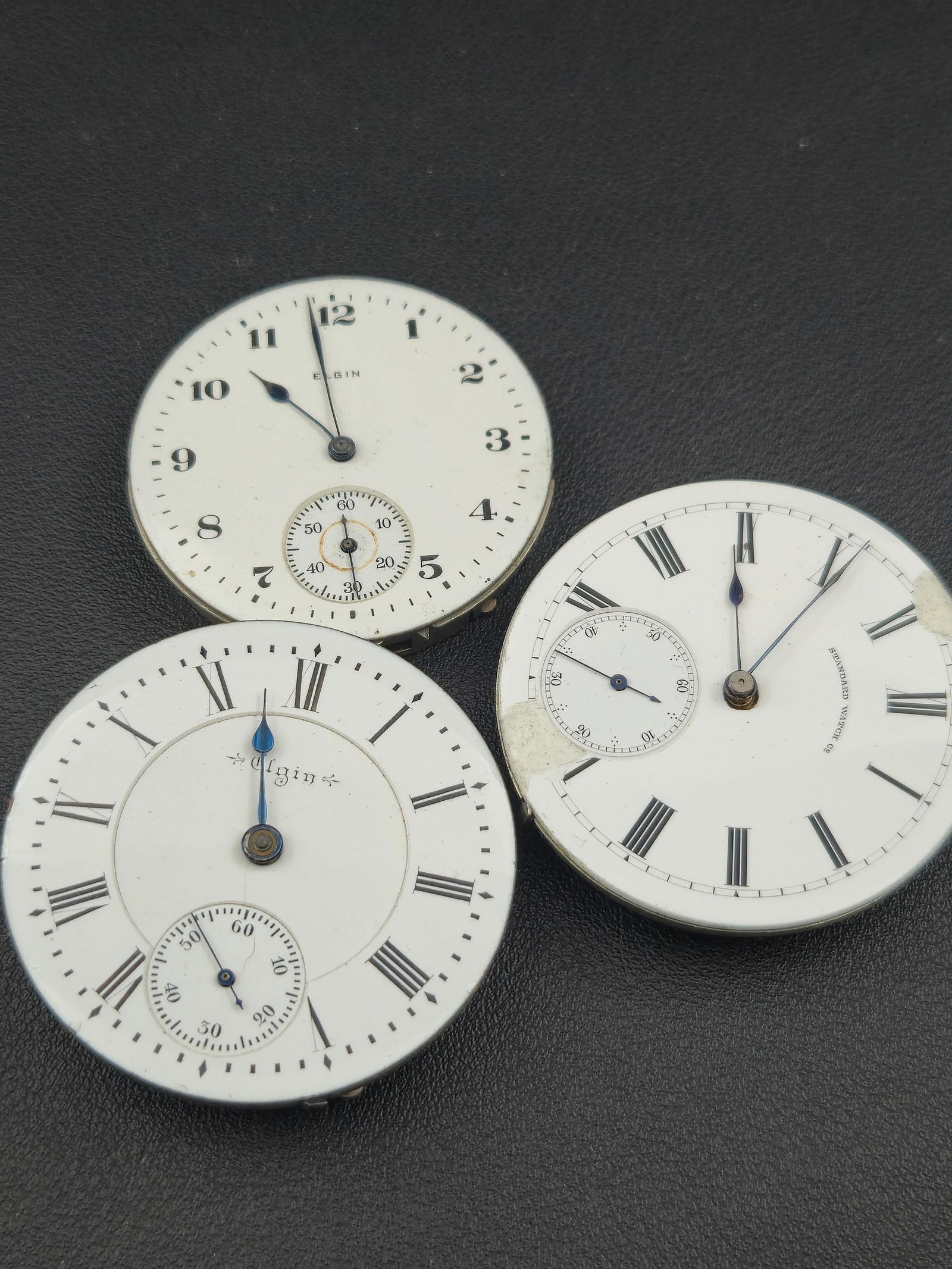 Lot of 3 Antique Pocket Watch Movements Elgin H H Taylor Standard Watch Co Untested: Group lot of three (3) antique pocket watch movements, including one clearly signed Elgin Natl Watch Co., one engraved H. H. Taylor, and one Standard Watch Co. dial and movement. All are mechanical mo