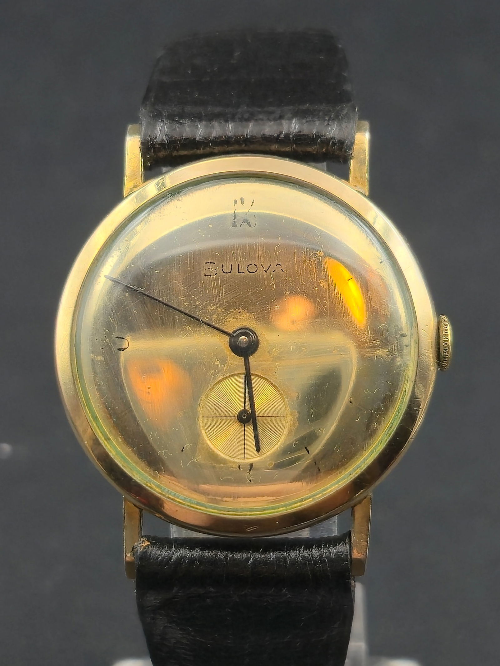 1958 Bulova L8 10K Rolled Gold Plate Mirrored Gold Dial Manual Wind Running: Vintage Bulova wristwatch featuring a mirrored gold dial with applied hour markers and subsidiary seconds at 6. The case is clearly stamped 10K Rolled Gold Plate with Bulova L8 date code, dating the w