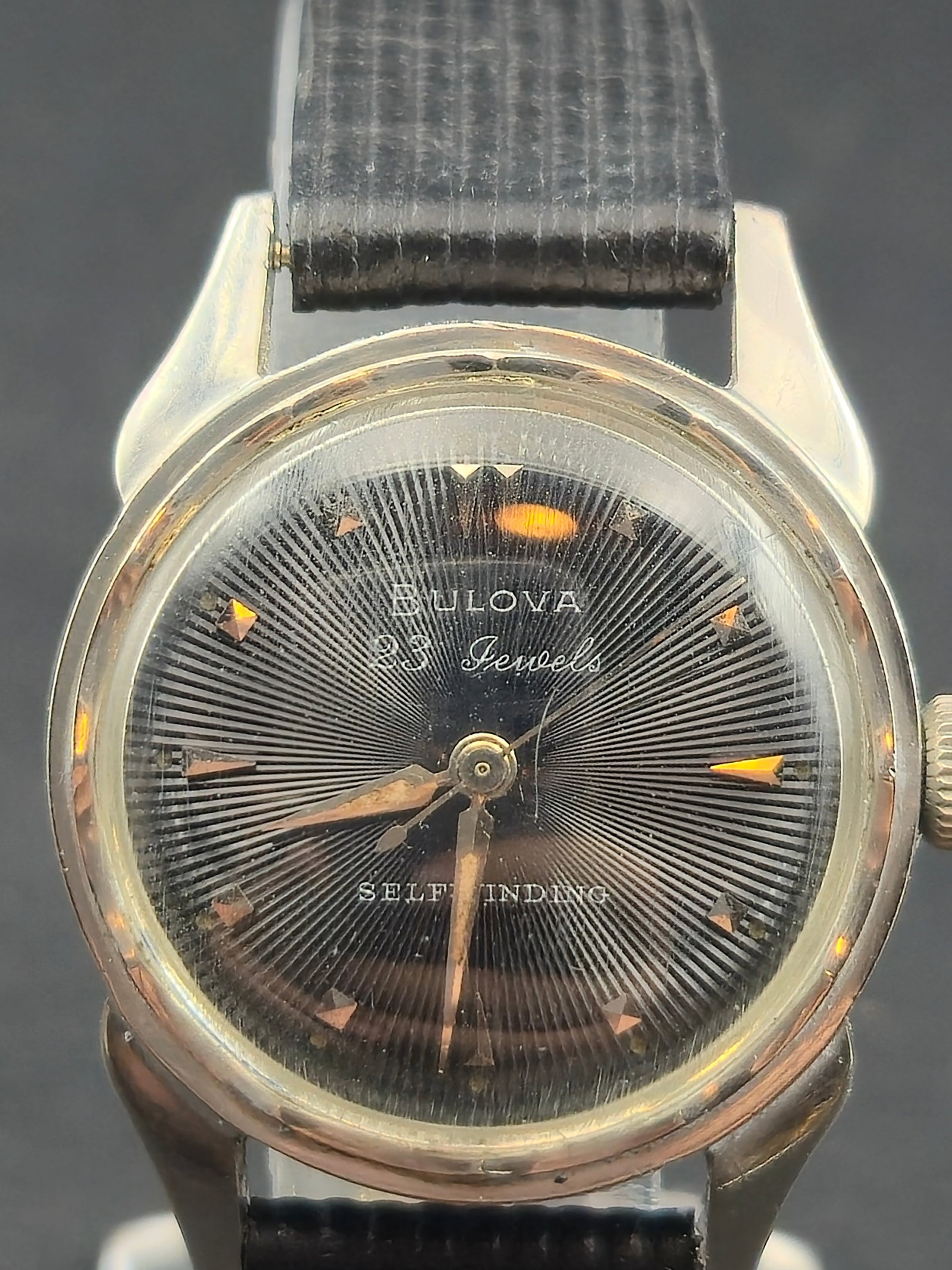 1959 Bulova L9 Automatic 23J Black Sunburst Dial Stainless Steel Swiss: Vintage 1959 Bulova automatic wristwatch featuring an eye-catching black sunburst dial with applied markers and classic mid-century styling. Powered by a 23-jewel Swiss self-winding movement, correctl