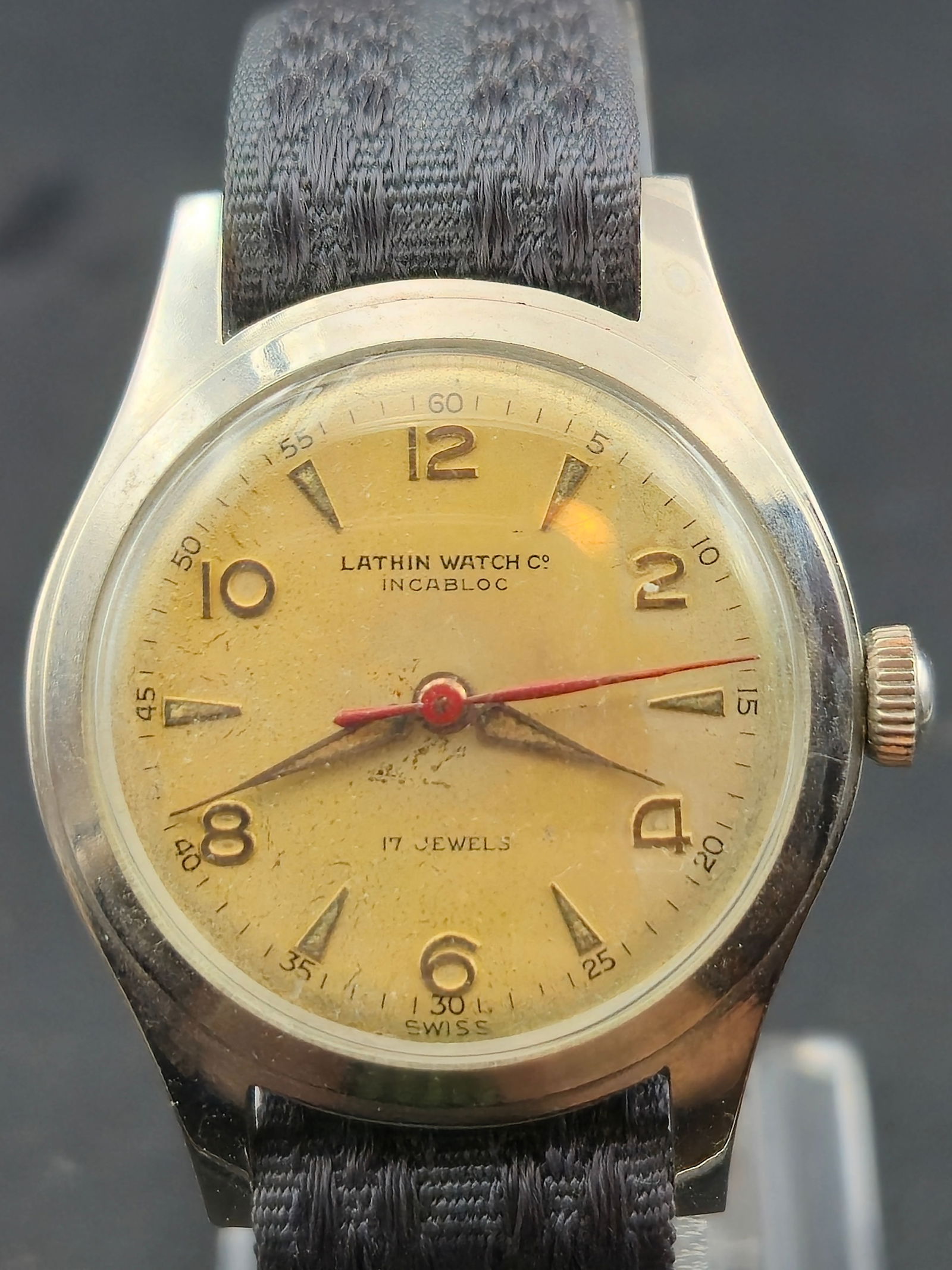 1960s Lathin Watch Co 17J Incabloc 30mm Swiss Manual Wind Watch Running: 1960s Lathin Watch Co Swiss manual wind wristwatch powered by a 17 jewel movement marked Seventeen 17 Jewels Lathin Watch Co Swiss and Unadjusted. Stainless steel case marked Shockproof, Incabloc, Swi