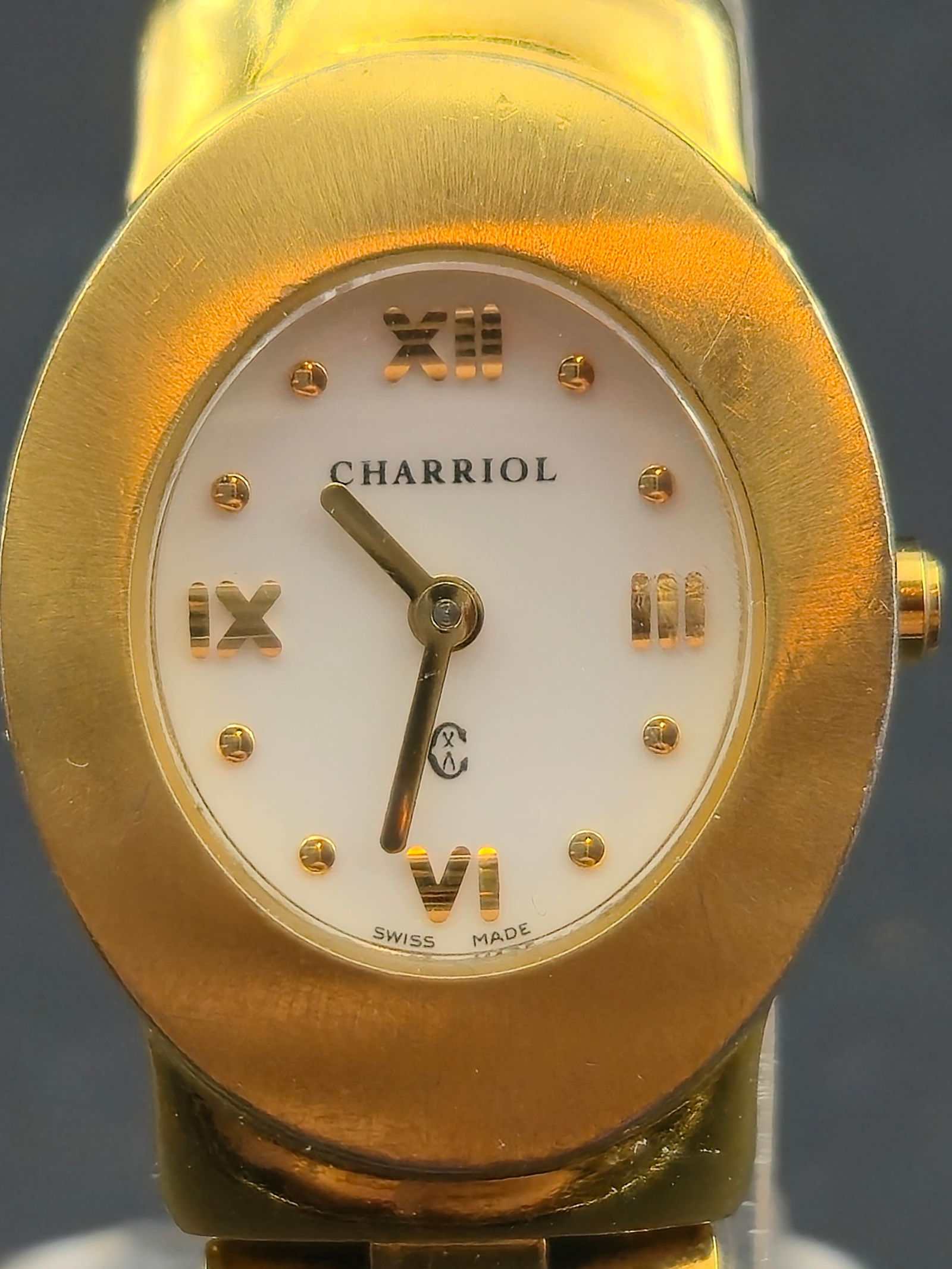 Charriol Azuro P Ladies Swiss Gold Tone 23mm Untested Ref AZUROP: Charriol ladies Swiss made wristwatch, reference AZUROP, serial number 00757. White dial with applied gold tone Roman numerals and dot markers. Oval gold tone case and integrated bracelet. Caseback ma