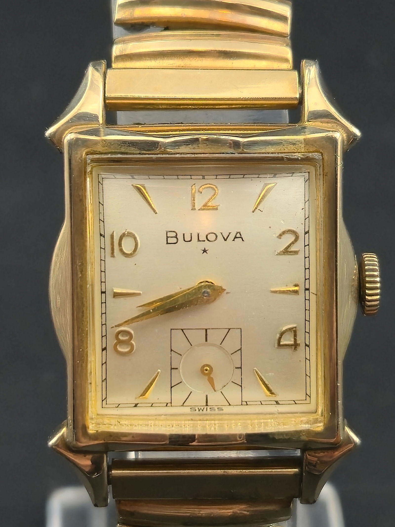1944 Bulova 10K Rolled Gold Plate Tank 25mm Manual Sub Seconds L4 Untested: Vintage Bulova rectangular tank wristwatch dated L4 (1944 production). Classic Art Deco styling with cream dial, applied gold tone Arabic numerals, sub seconds at 6, and signed Bulova dial with star.C