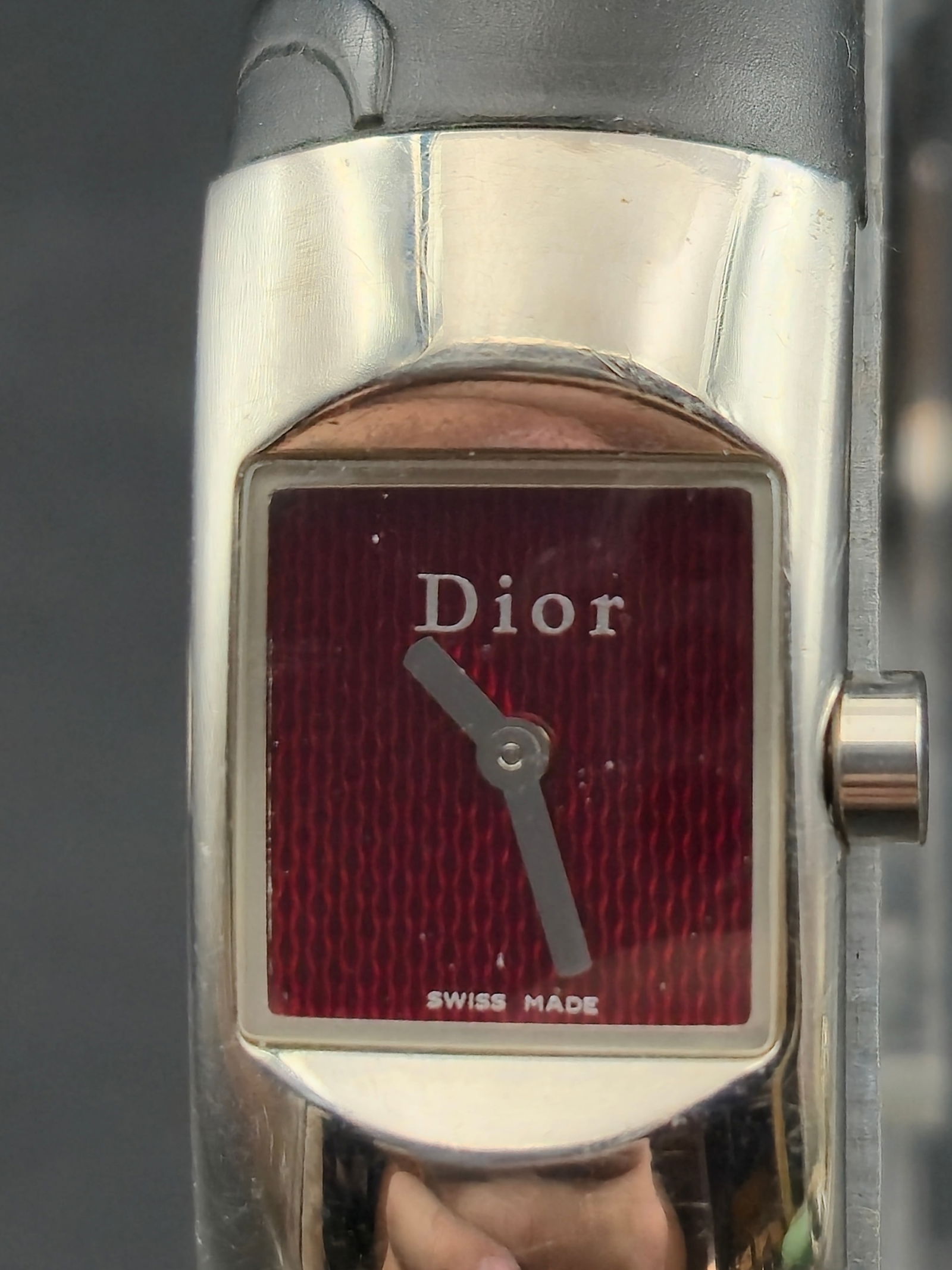 Christian Dior D102-100 Swiss Quartz 15mm Red Dial Steel Runs: Christian Dior Swiss made quartz wristwatch reference D102-100.Rectangular polished stainless steel case secured by four visible screws on caseback. Caseback signed Christian Dior, Water Resistant, Sw