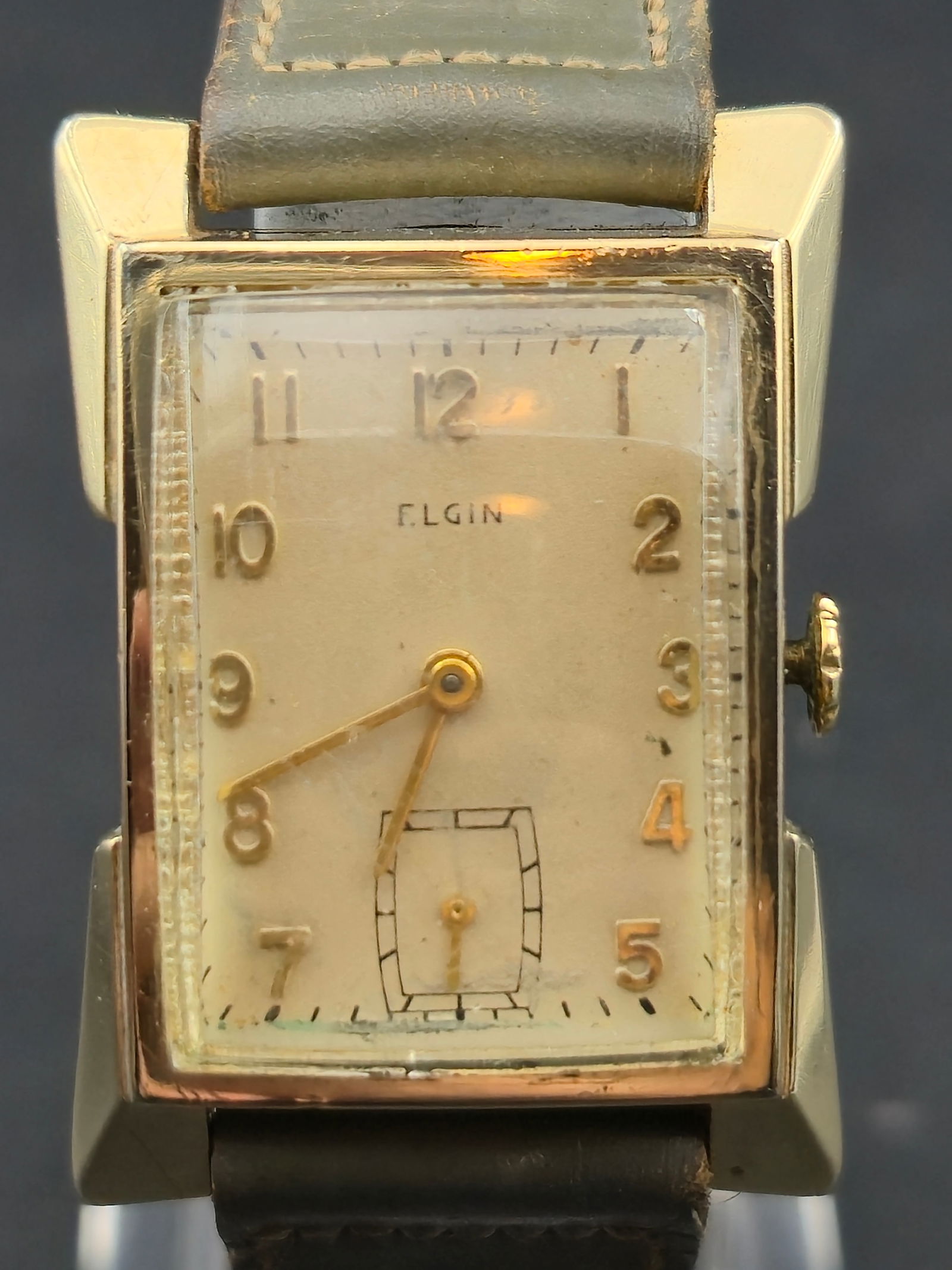 1940s Elgin 557 14K GF Tank Sub Seconds Arabic Dial 22mm: 1940s Elgin rectangular tank housed in a 14K gold filled case by Hadsworth, case number 4630, serial X063799. Original silver dial with applied gold Arabic numerals, railroad minute track, and stylize