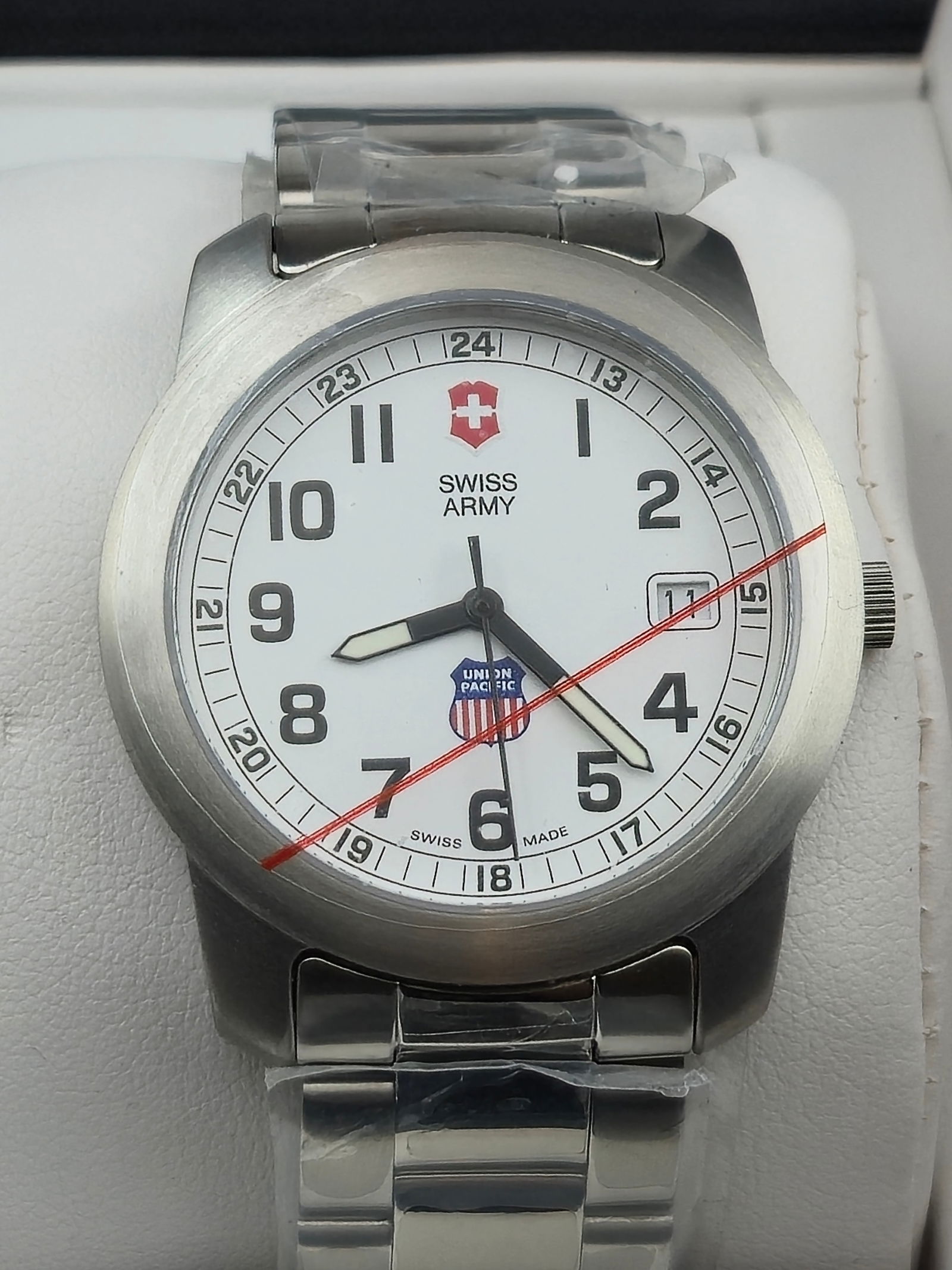 Victorinox Swiss Army Union Pacific 100M Stainless 43mm Quartz NOS New Battery Box: Victorinox Swiss Army stainless steel wristwatch featuring Union Pacific dial logo and date at 3. White dial with bold Arabic numerals, inner 24 hour track, luminous hands, and red seconds hand. Dial