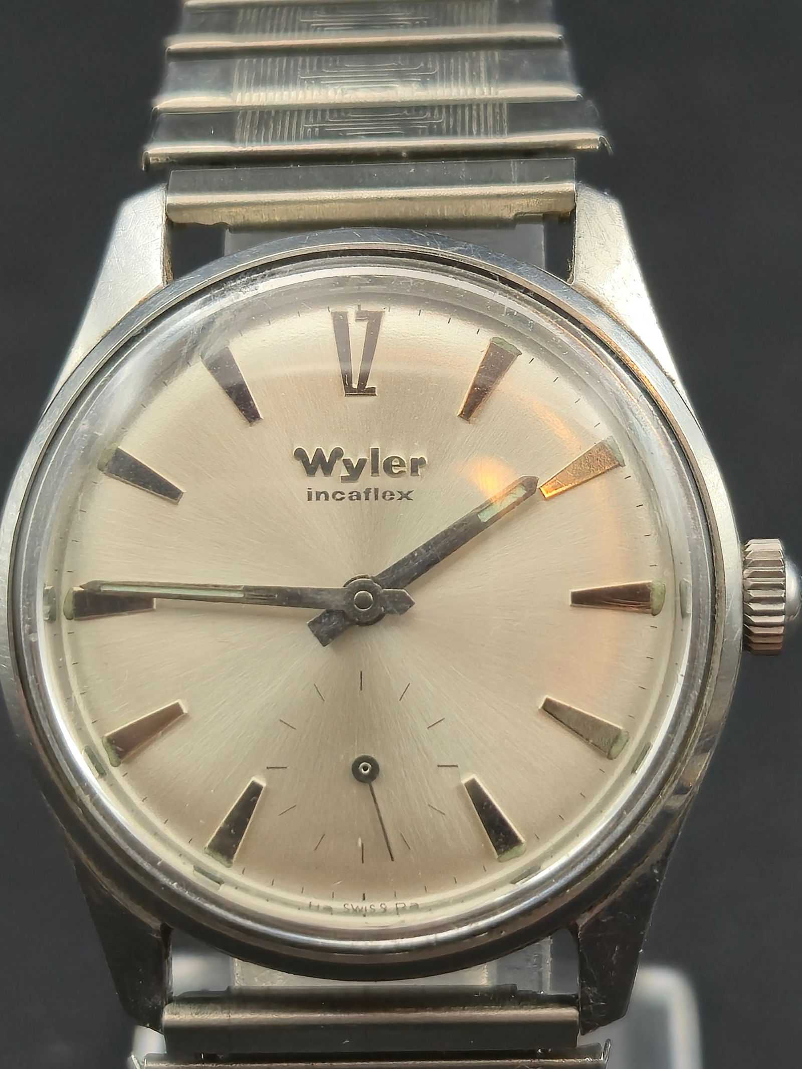 1960s Wyler Incaflex 17J WM212 Manual Wind 31mm Stainless Steel Running: Vintage 1960s Wyler Incaflex wristwatch featuring silver sunburst dial with applied baton markers and applied Roman XII. Dial marked Wyler Incaflex.Powered by Wyler Watch Co Swiss 17 jewel manual wind
