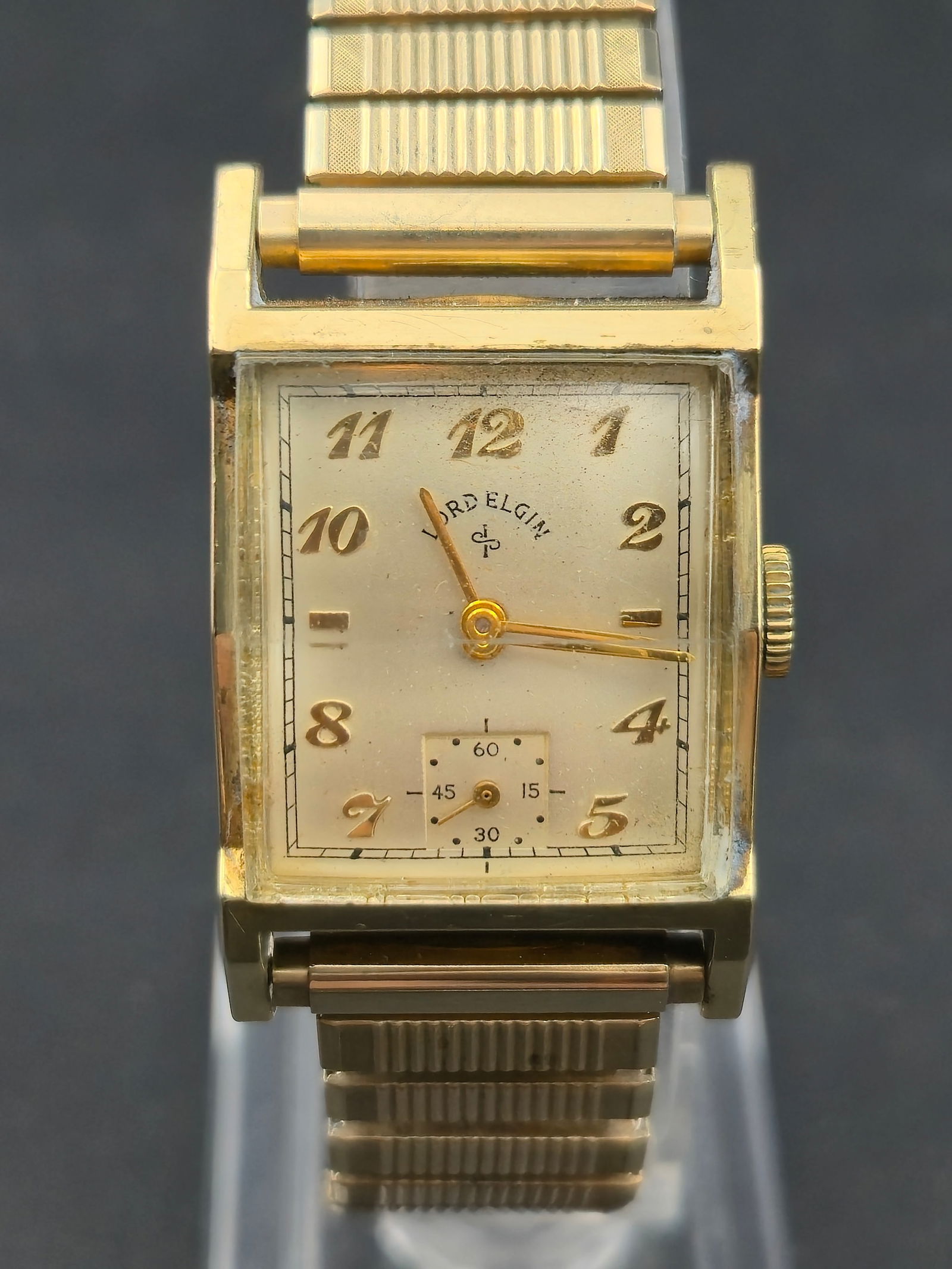 1949 Lord Elgin Cal 626 21J 4 Adj 14K Gold Filled 23mm Engraved Speidel 10K RGP Box: Vintage 1949 Lord Elgin rectangular wristwatch powered by Elgin caliber 626 manual wind movement, 21 jewels, adjusted 4 positions. Movement marked Elgin 626 USA 21 Jewels 4 Adjs.Case marked 14K Gold F