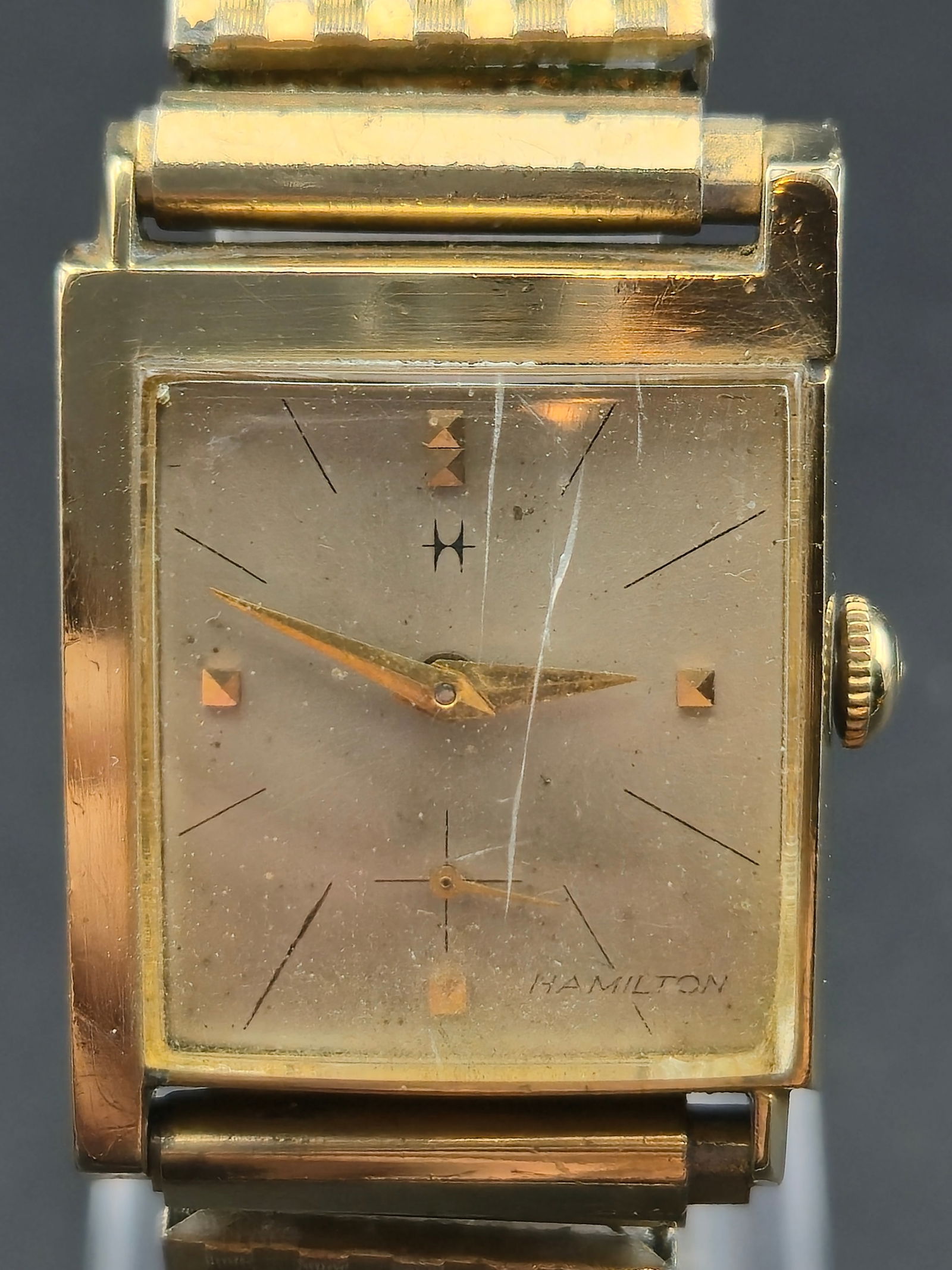 1950s Hamilton 770 22J 10K Gold Filled 24mm Tank Manual: Vintage Hamilton tank style wristwatch featuring a square case and silver dial with applied gold pyramid and baton markers, subsidiary seconds at 6, and applied Hamilton script. Case interior marked H