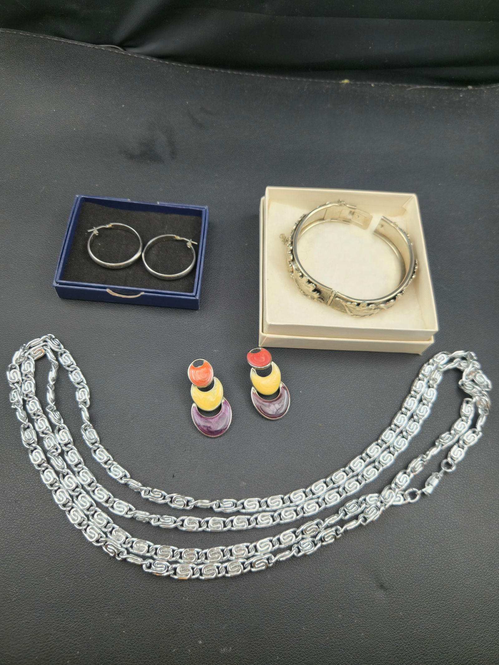 Vintage Silver Tone Greek Key Chain Bangle & Enamel Earrings Lot: Vintage silver-tone jewelry grouping including Greek key style chain necklace, ornate floral hinged bangle bracelet, pair of silver-tone hoop earrings, and multicolor enamel drop earrings. Coordinated