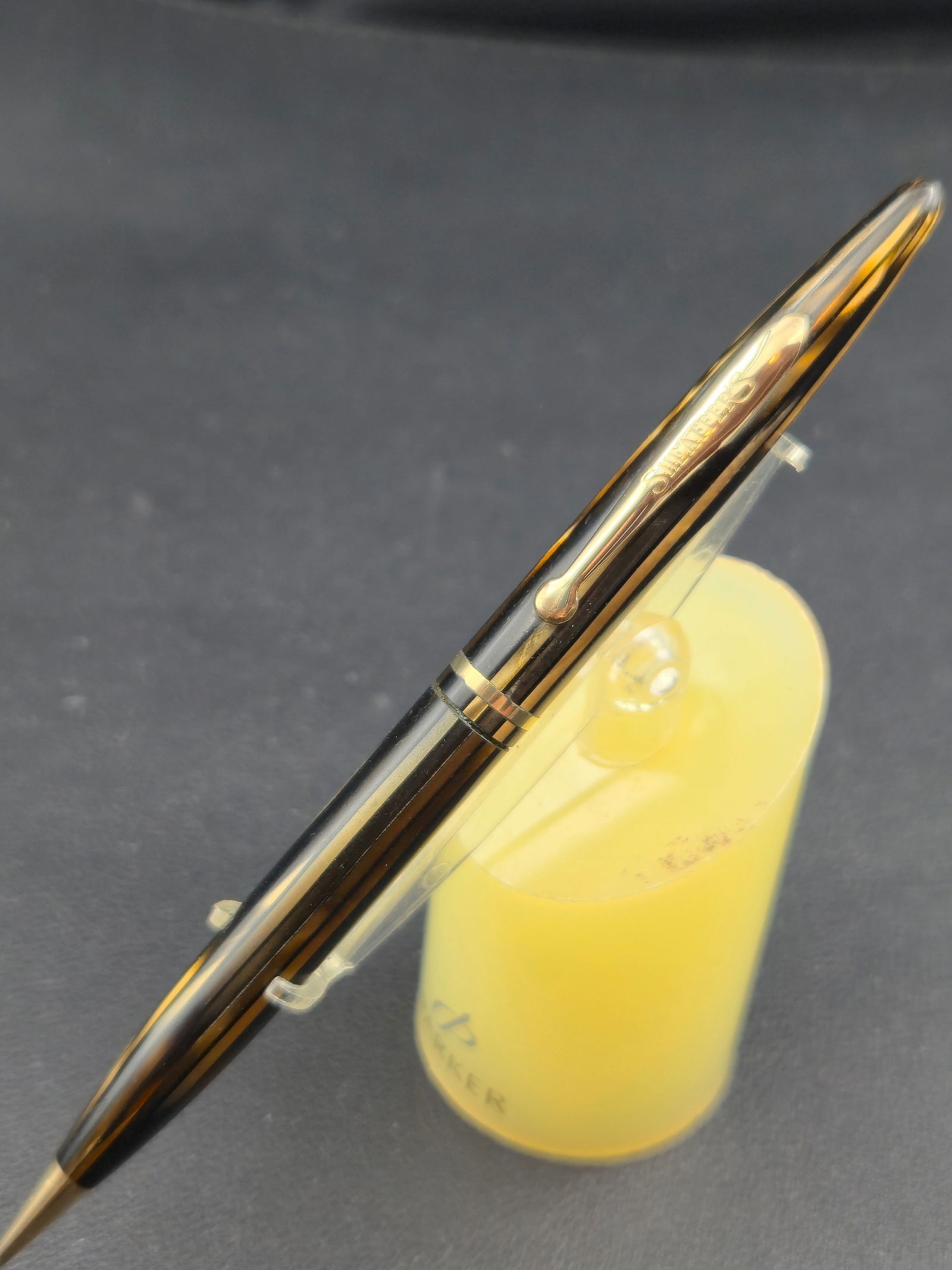 Vintage Sheaffer 300 White Dot Mechanical Pencil Black Gold Filled Cap USA: Vintage Sheaffer Model 300 mechanical pencil in black with gold filled cap and trim. Barrel marked 300. Cap marked Sheaffer and Made in USA with U.S. patent numbers visible. White dot on clip indicati