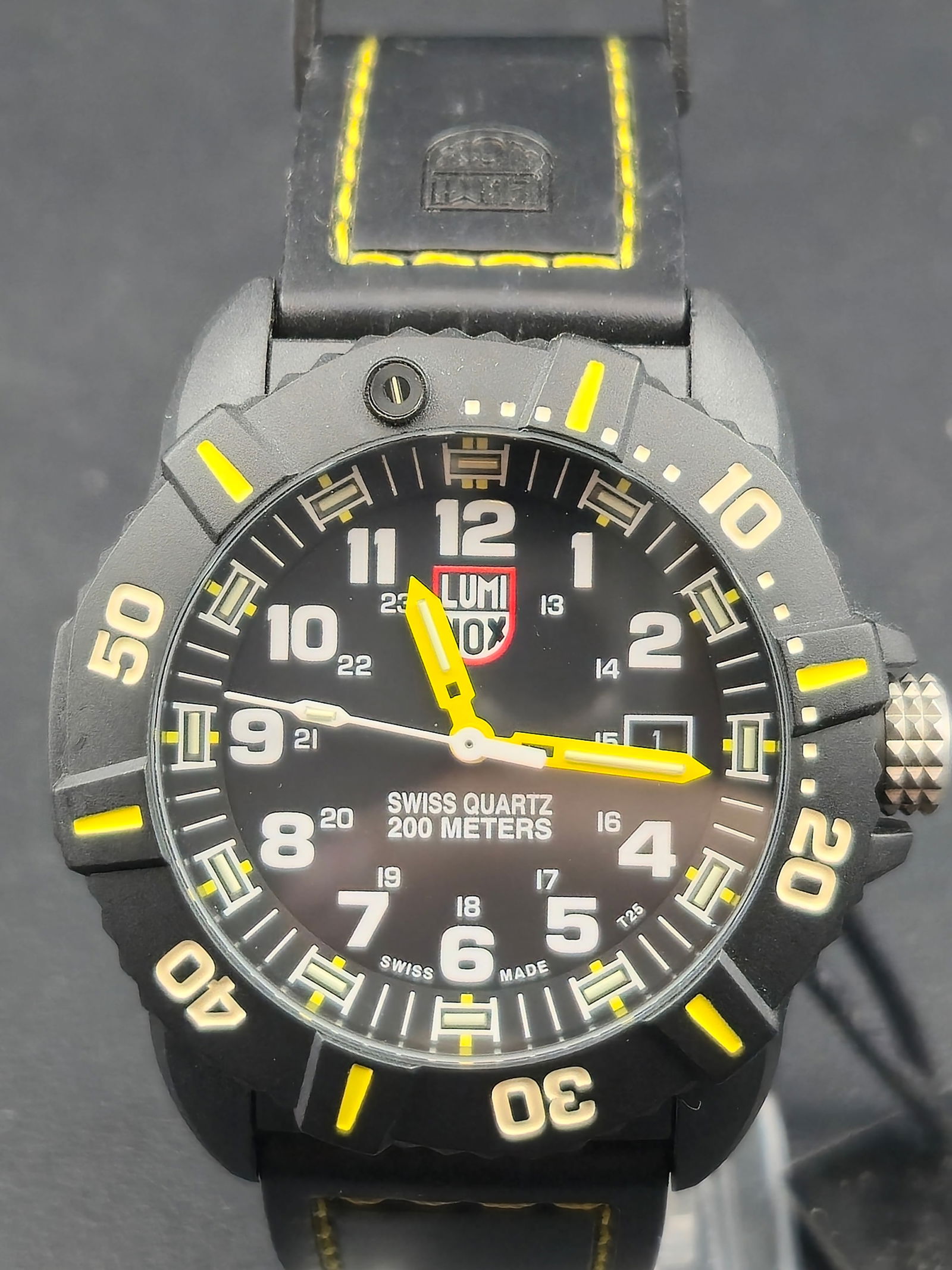 1990s Luminox Navy SEAL Series 3020 44mm PC Carbon 200m Swiss Quartz Date Watch Running New Battery: 1990s Luminox Navy SEAL Series 3020 Swiss quartz dive watch with black dial, yellow accent hands and bezel markers, and date at 3. Dial marked Swiss Quartz 200 Meters and Swiss Made T25. Unidirectiona