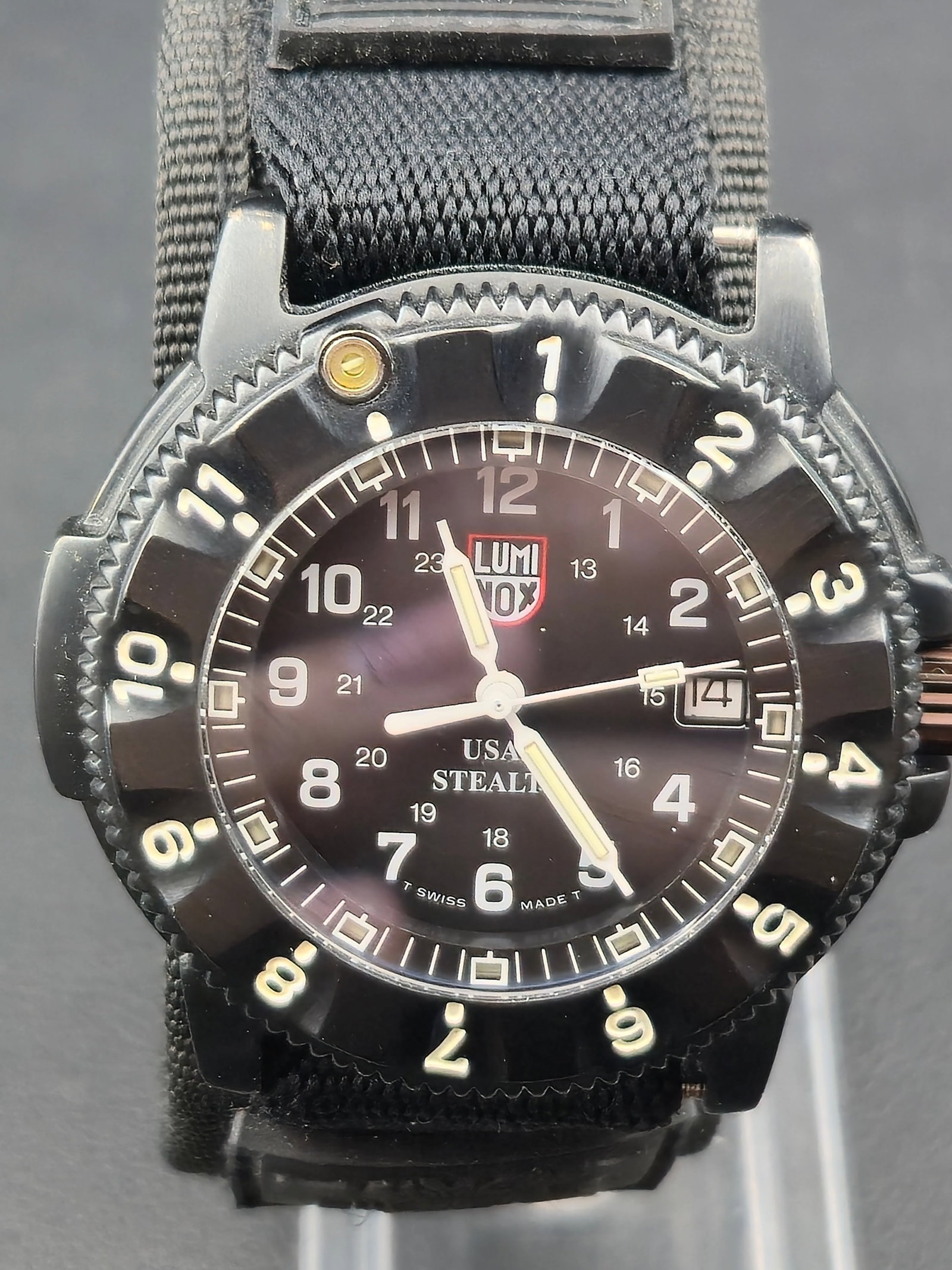 Luminox USAF Stealth F-117 Night Hawk Series 3400 42mm 200m Swiss Quartz Watch New Battery: Luminox USAF Stealth F-117 Night Hawk Series 3400 Swiss quartz watch featuring black dial with inner 24-hour scale and date at 3. Dial marked USAF Stealth and Swiss Made. Unidirectional rotating bezel
