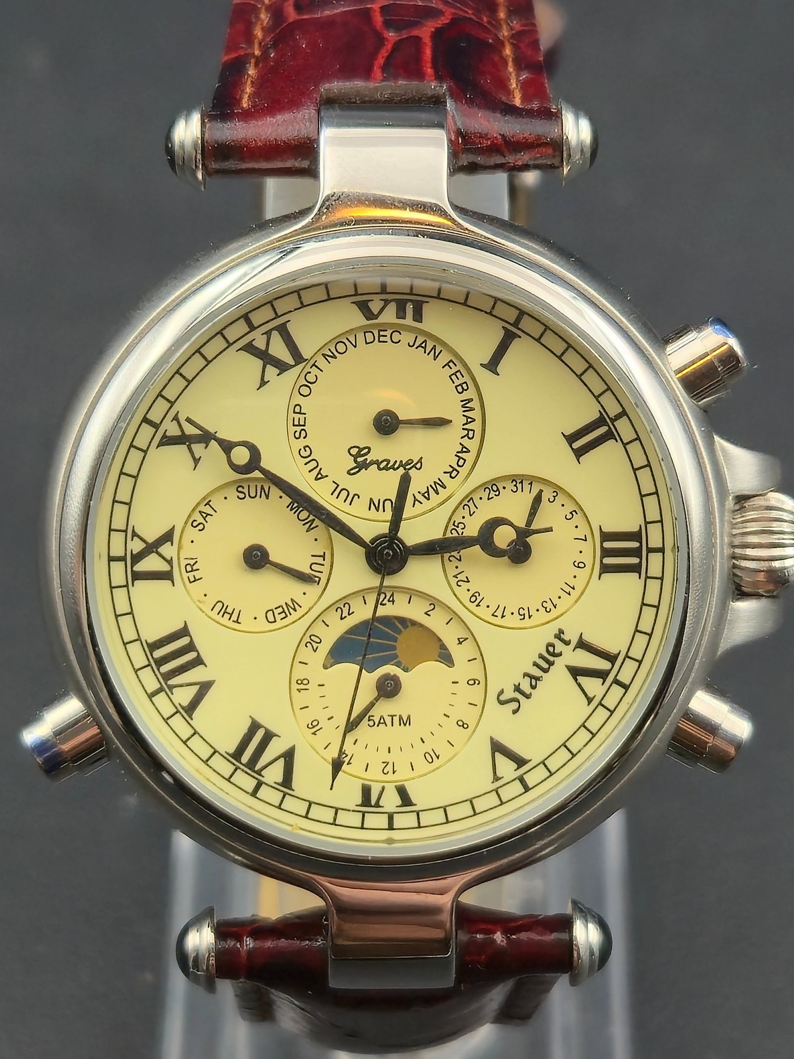 Stauer Graves 1372 Premier 5ATM Triple Calendar Moonphase NOS Running Full Set: Stauer Graves Premier Collection wristwatch, reference 1372, stainless steel case with cream Roman numeral dial and triple calendar moonphase layout. Features month, day, date, 24-hour subdial, and mo