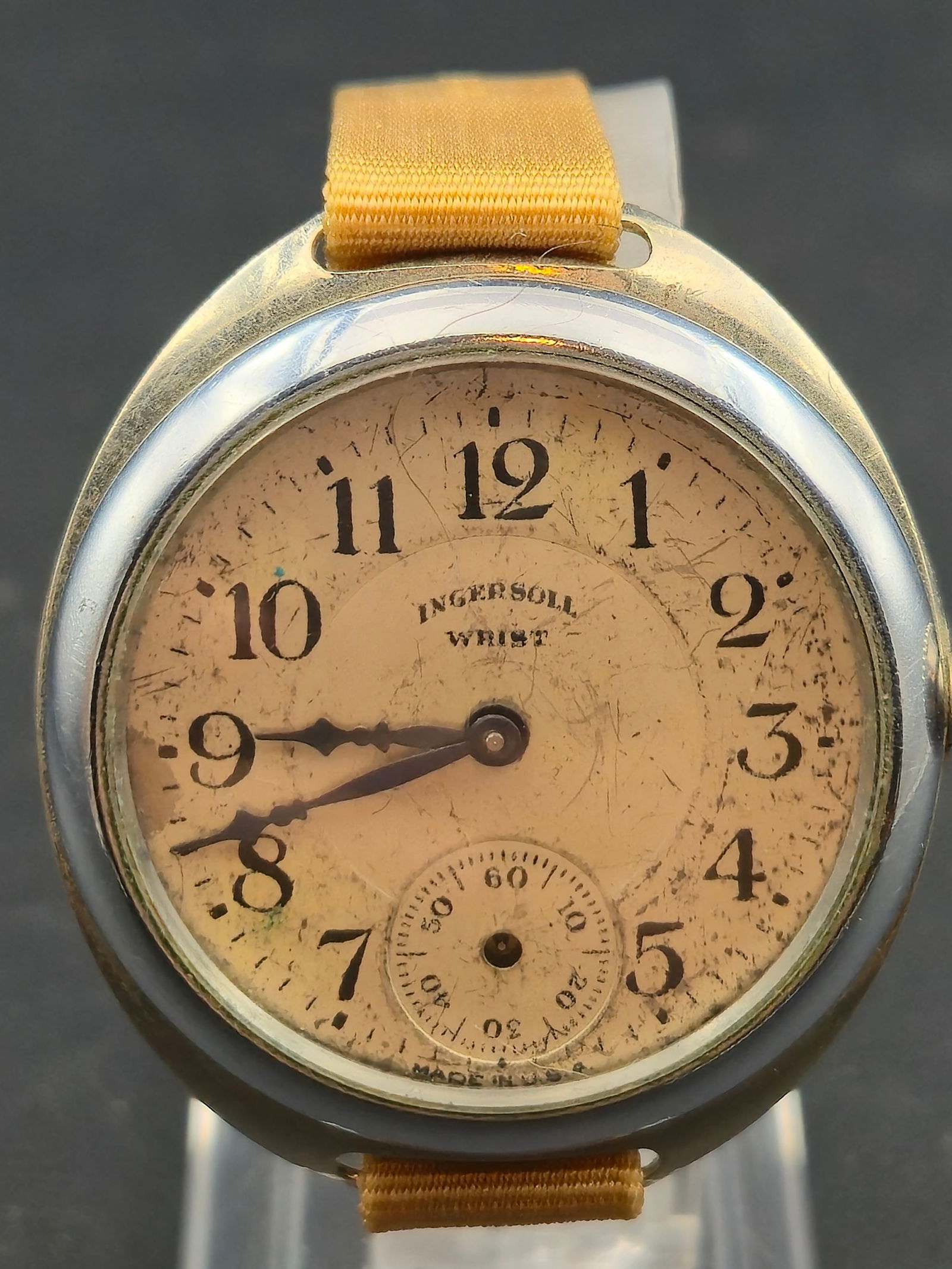 1904 Ingersoll Wrist Watch Trench Style 31mm Nickel Case Manual Wind: Early American wristwatch by Ingersoll, commonly referred to as a “trench watch” style, featuring a cream enamel dial with Arabic numerals, small seconds at 6 o’clock, and cathedral-style ha