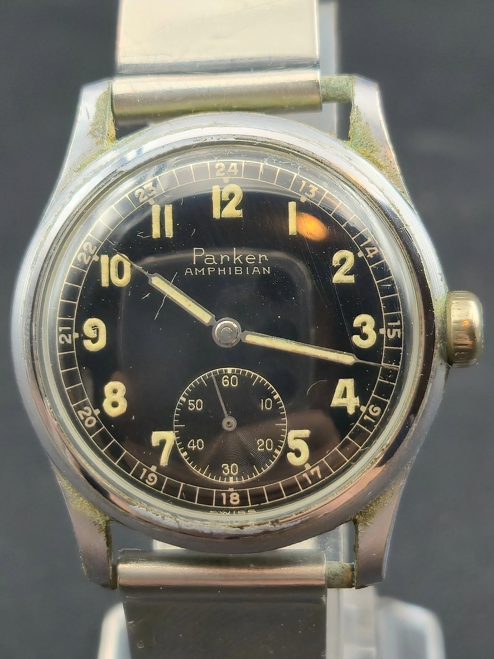 Parker Amphibian 17 Jewel Manual Wind Watch 32mm Black Dial Subseconds Swiss: Vintage Parker wristwatch with black dial signed Parker Amphibian. The dial features Arabic numerals, luminous hands and markers, and a subseconds register at the 6 o’clock position. An inner 24-hou