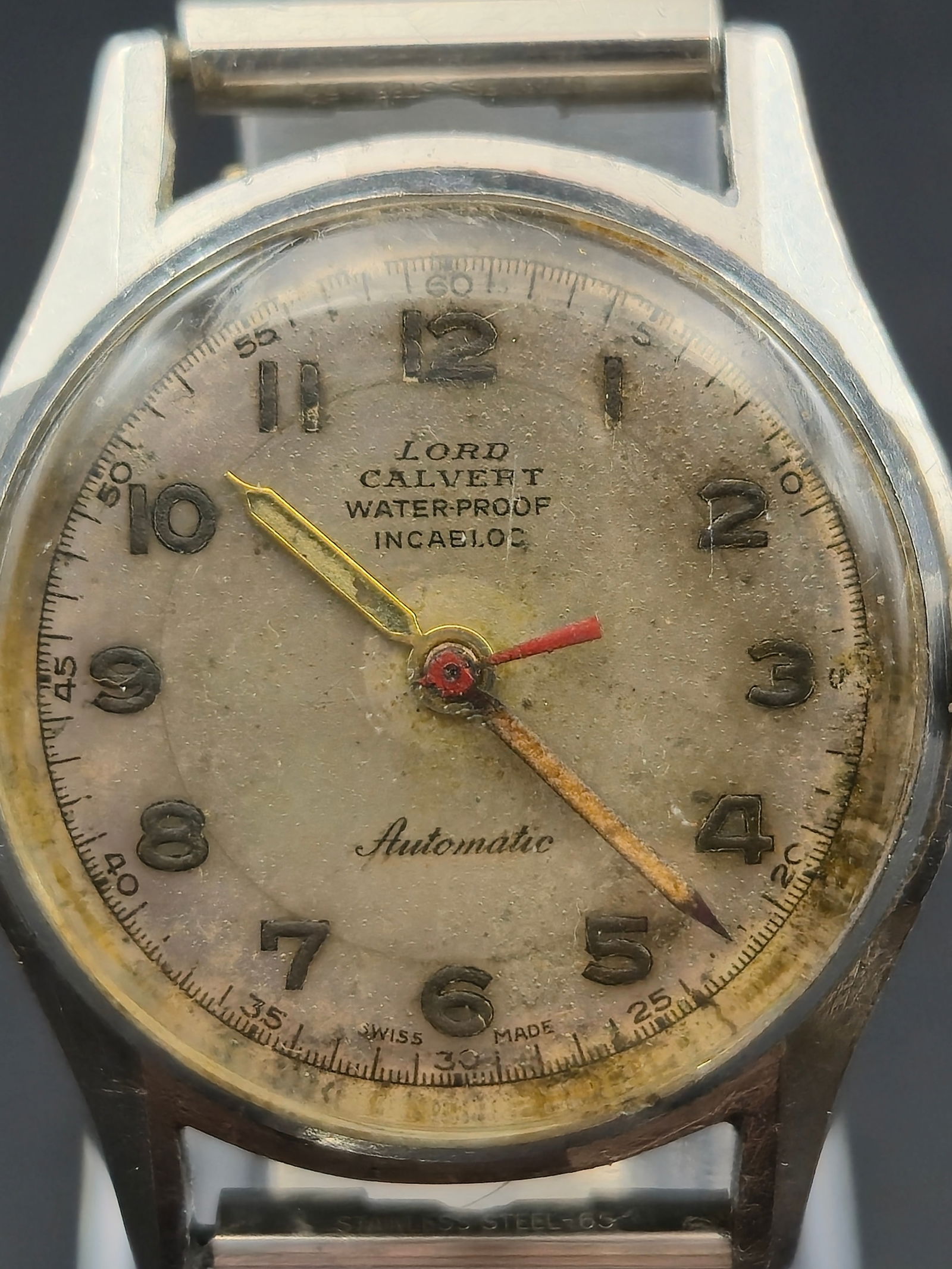 Lord Calvert Automatic 17 Jewel Watch 30mm Incabloc Swiss Running: Vintage wristwatch with dial signed Lord Calvert featuring Arabic numerals, center seconds with red tip, and text reading Water-Proof Incabloc above Automatic. The dial shows noticeable aging and spot