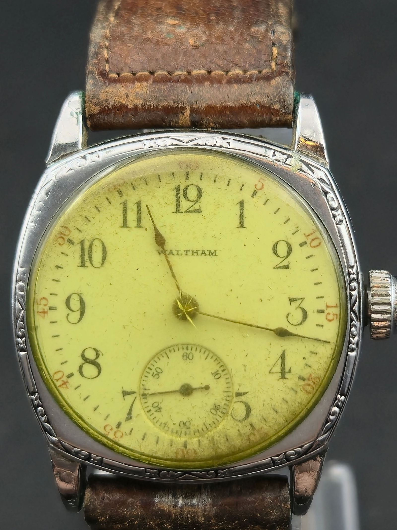 Waltham A.W.W.Co Subseconds Watch 31mm Starwhite Case SWC Co: Vintage wristwatch with dial signed Waltham featuring Arabic numerals and a subseconds register at the 6 o’clock position. The dial shows heavy aging and spotting. The crystal appears yellowed from