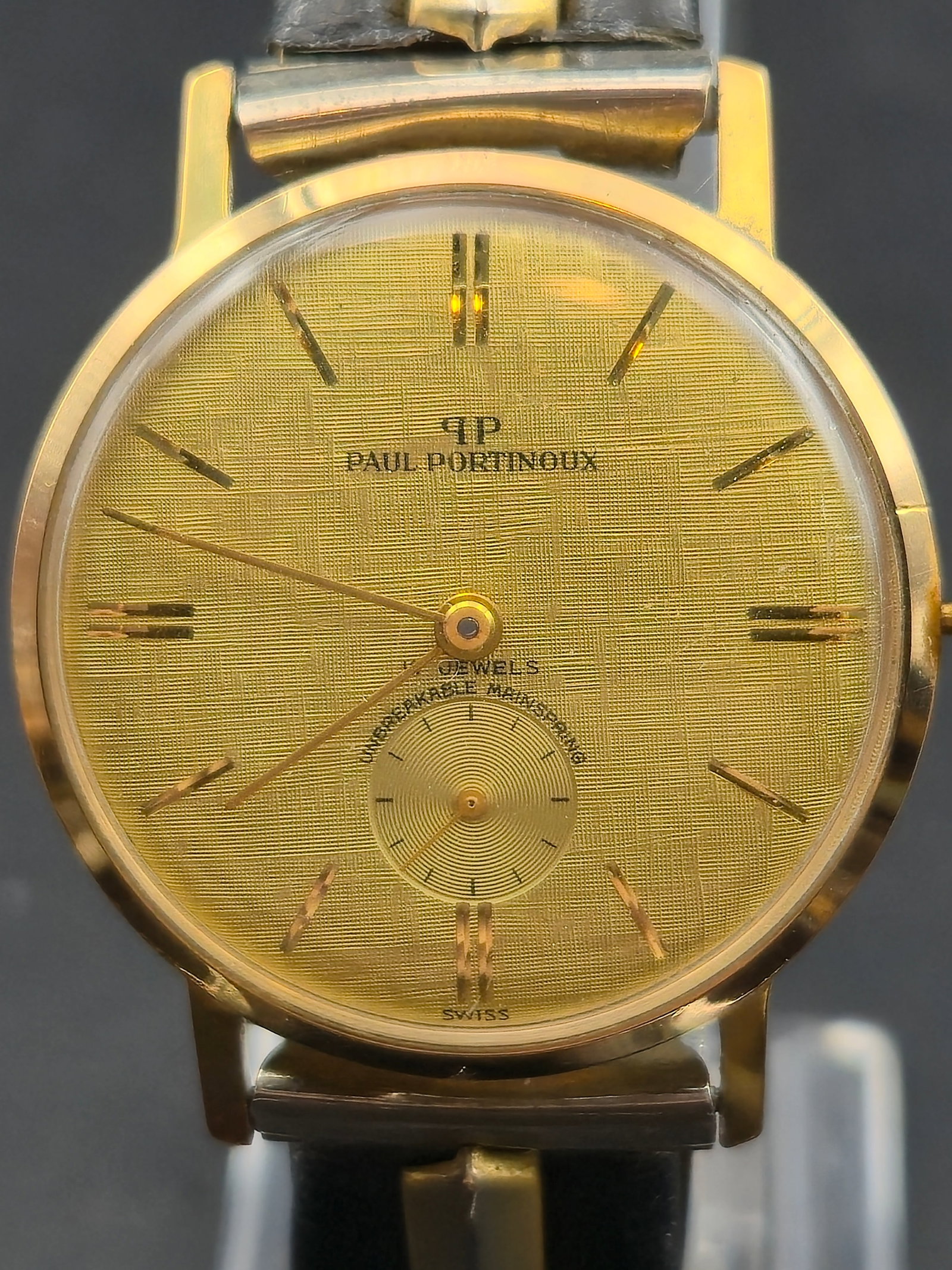 1960s Paul Portinoux Swiss 17J Linen Dial Sub Seconds Gold Plated Watch 33mm Running: Vintage Paul Portinoux wristwatch featuring a textured gold linen dial with applied baton markers and subsidiary seconds at 6. The dial is signed PP Paul Portinoux and marked 17 jewels unbreakable mai