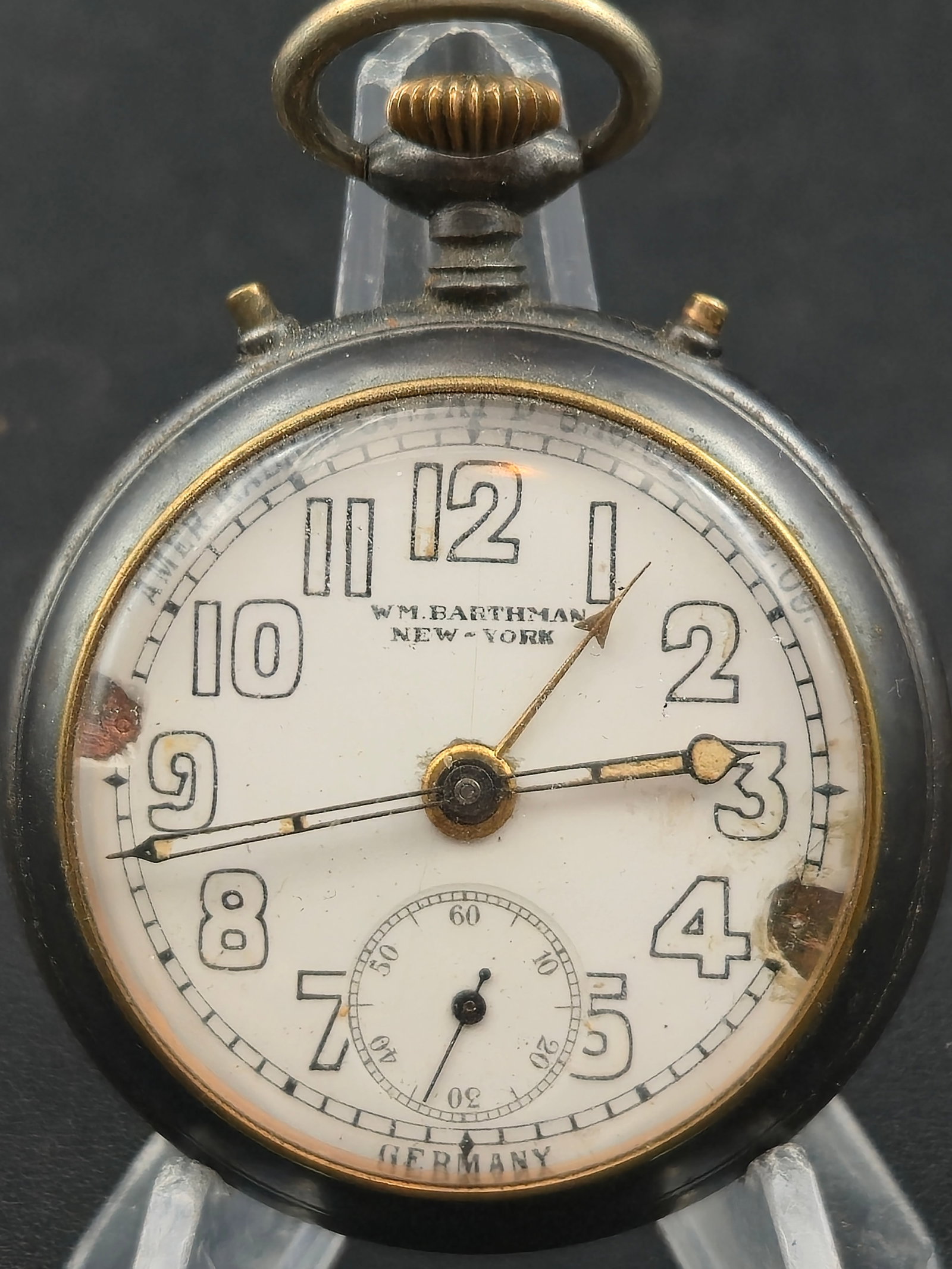 Circa 1915 WM Barthman New York Radium Dial Gunmetal Pocket Watch 11J Germany 52mm Running: Vintage pocket watch signed WM. Barthman New York, a well-known New York retailer. The enamel dial features large Arabic numerals with a sub-seconds register at 6 and is marked Germany. The chapter ri