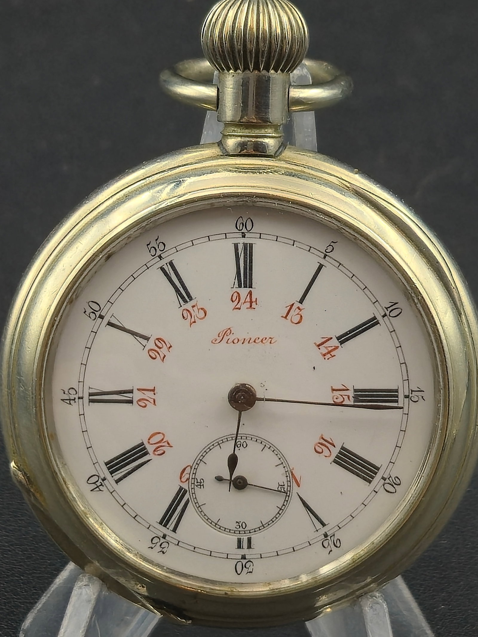 c.1900 Pioneer Swiss Pocket Watch 56mm Roman Dial Red 24hr Sub Seconds Running: Antique pocket watch with enamel dial signed “Pioneer” featuring Roman numerals with inner red 24-hour track and sub-seconds at 6.Mechanical hand-wind movement with visible serial No. 599319.