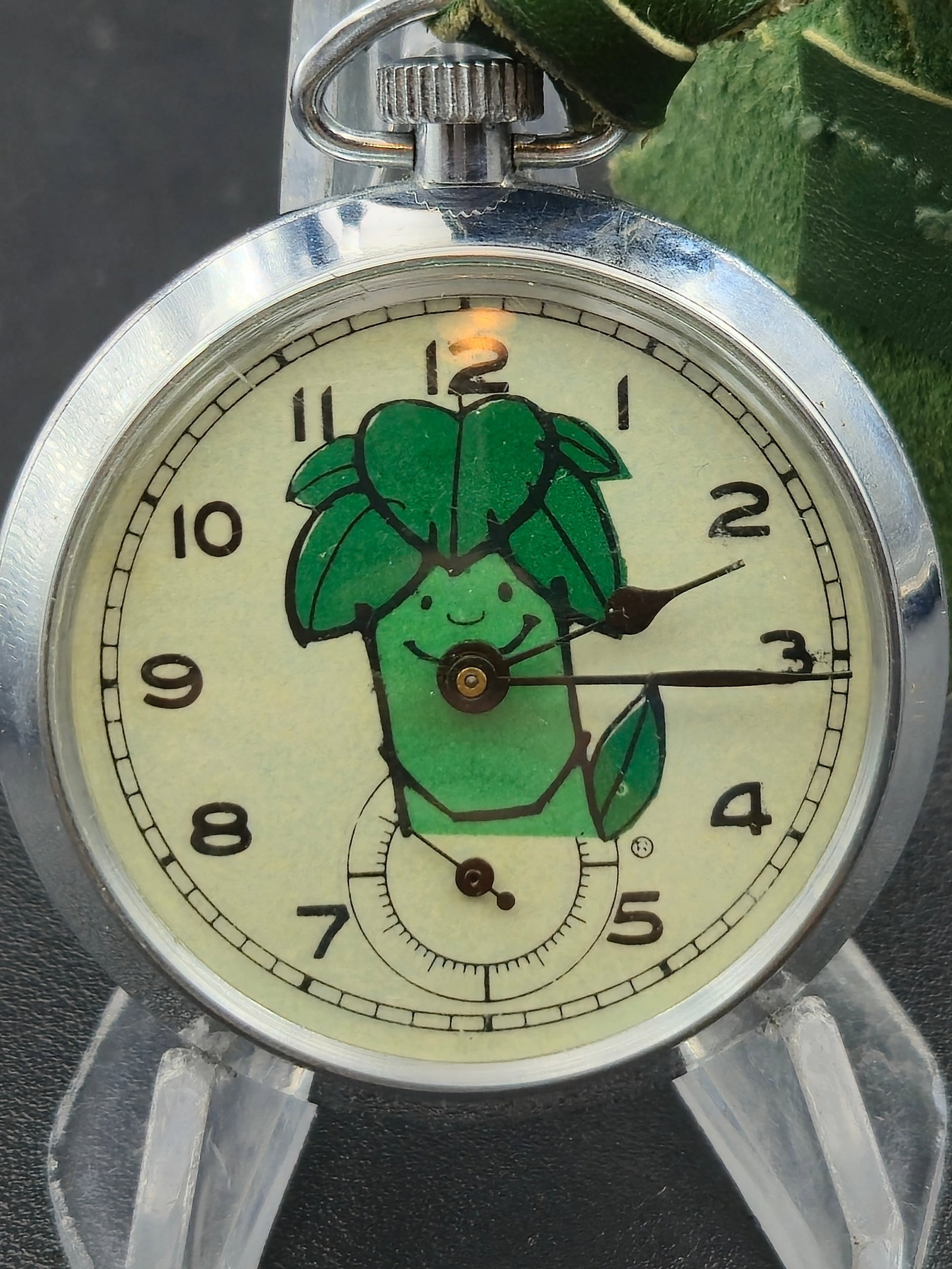 Green Giant Advertising Pocket Watch UMF Ruhla Germany c1970s Novelty 50mm Running: Vintage novelty pocket watch featuring a Green Giant advertising dial, depicting the iconic vegetable mascot in bright green with Arabic numerals and sub-seconds. The movement is marked UMF 83, produc