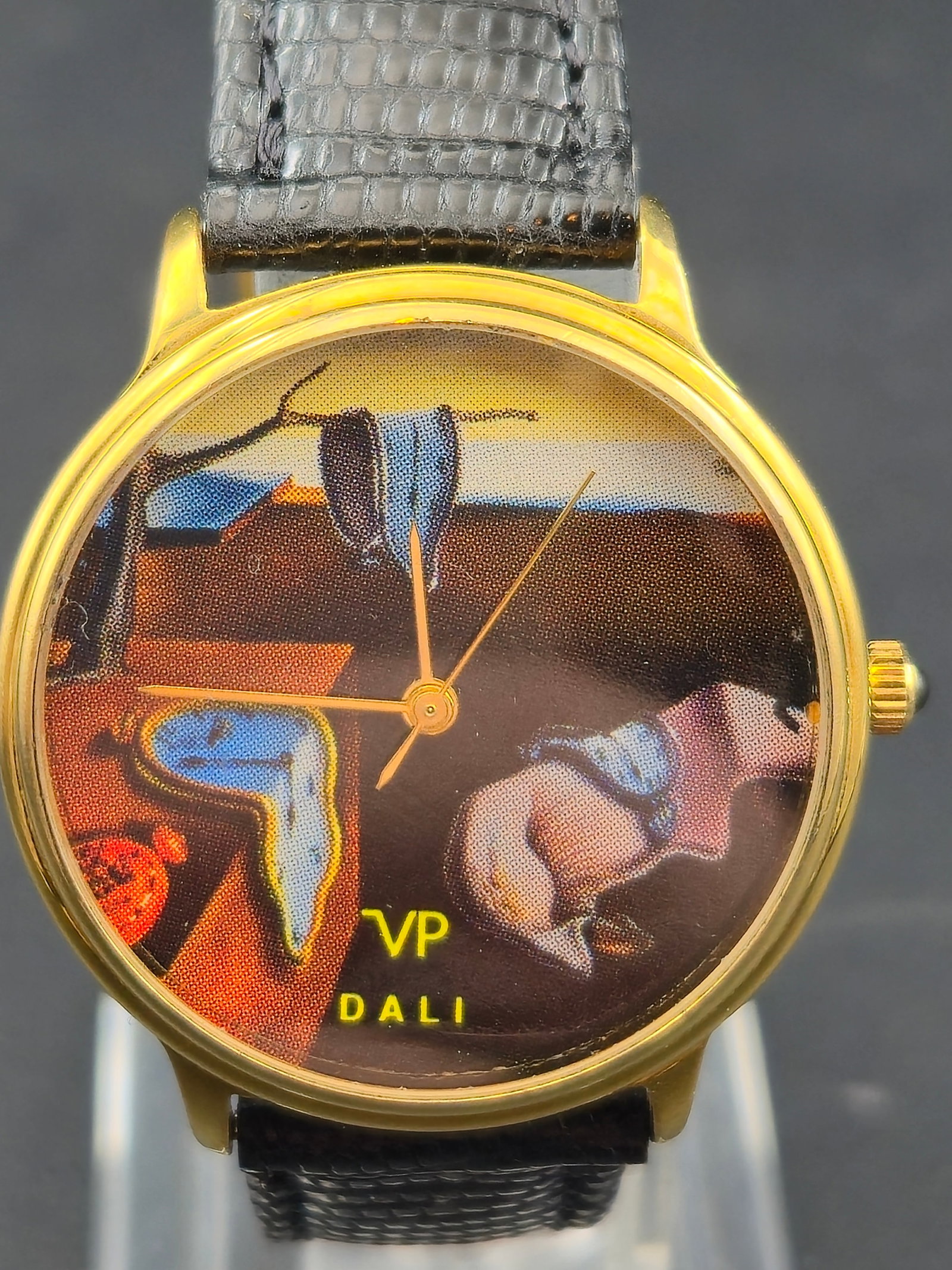 Salvador Dali Melting Clocks Surreal Art Dial Quartz Watch Gold Tone Case Vintage 1990s Mens: Vintage Salvador Dali inspired quartz wristwatch featuring the iconic melting clocks surrealist artwork dial. Gold tone case with minimalist hands and black textured leather strap. Classic novelty art
