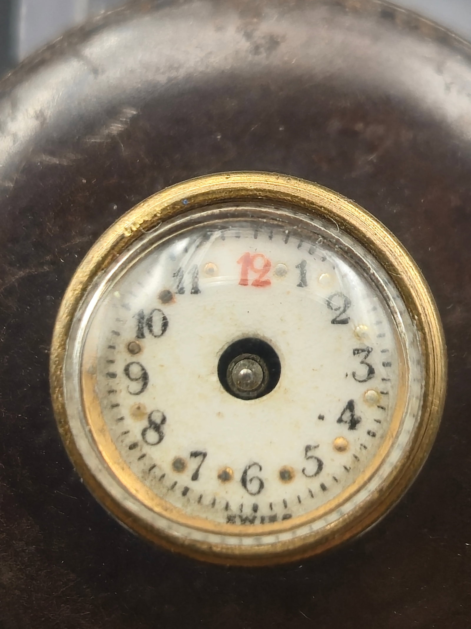 c1900 Swiss Button Watch Mechanical Miniature Novelty Desk Case 13mm Untested: Antique Swiss button watch housed in a miniature novelty desk-style case, dating to circa 1900. Features a very small mechanical movement with white dial and red 12, set within a larger outer holder.