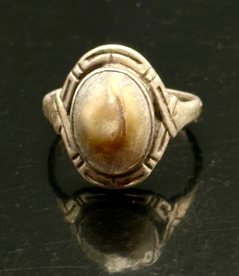 Antique Sterling Silver Elk Tooth Ring c.1900 Fraternal Elks Style 9g: An antique sterling silver ring dating to circa 1900–1930, set with a natural elk tooth (ivory), also known as “ivorie.”The ring features a raised oval cabochon with natural cream and tan co