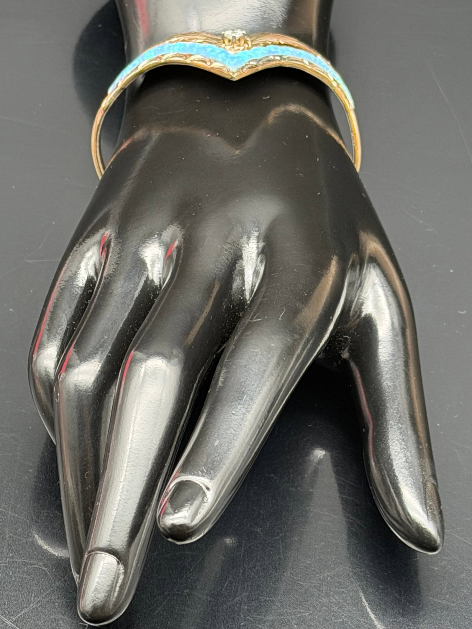 16g- Vintage Sterling Native American Navajo Feather Cuff Bracelet: A striking V-shaped (chevron) cuff bracelet featuring an elaborate feather motif engraved across the entire surface. The bracelet forms a dramatic pointed V at the center front, with intricate hand-en