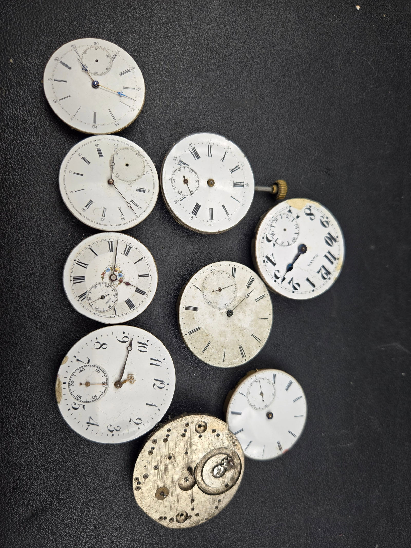 Vintage Pocket Watch Parts Lot Elgin Waltham Swiss Dials Movements 8 Days Untested: Mixed antique pocket watch parts lot including Elgin, Waltham, Swiss, and unmarked movements and dials.This group features multiple enamel dials with Roman numerals, including an “8 Days” dial