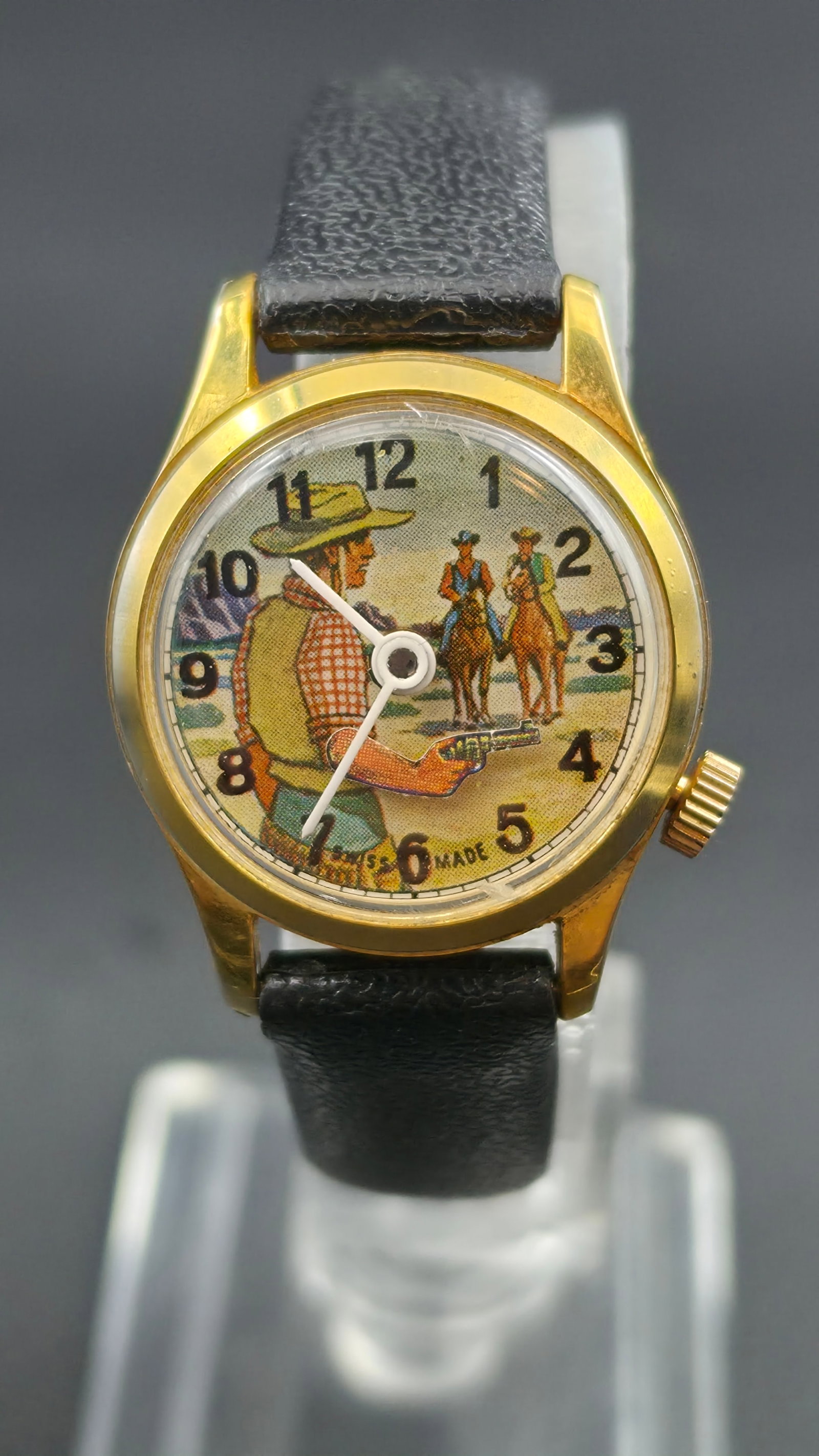 Vintage Swiss Cowboy Novelty Watch 25mm Mechanical Western Dial Montana Ltd Runs: Vintage Swiss-made mechanical wristwatch featuring a detailed Western cowboy scene dial with Arabic numerals and small seconds subdial. Dial depicts a cowboy with revolver and riders in the background